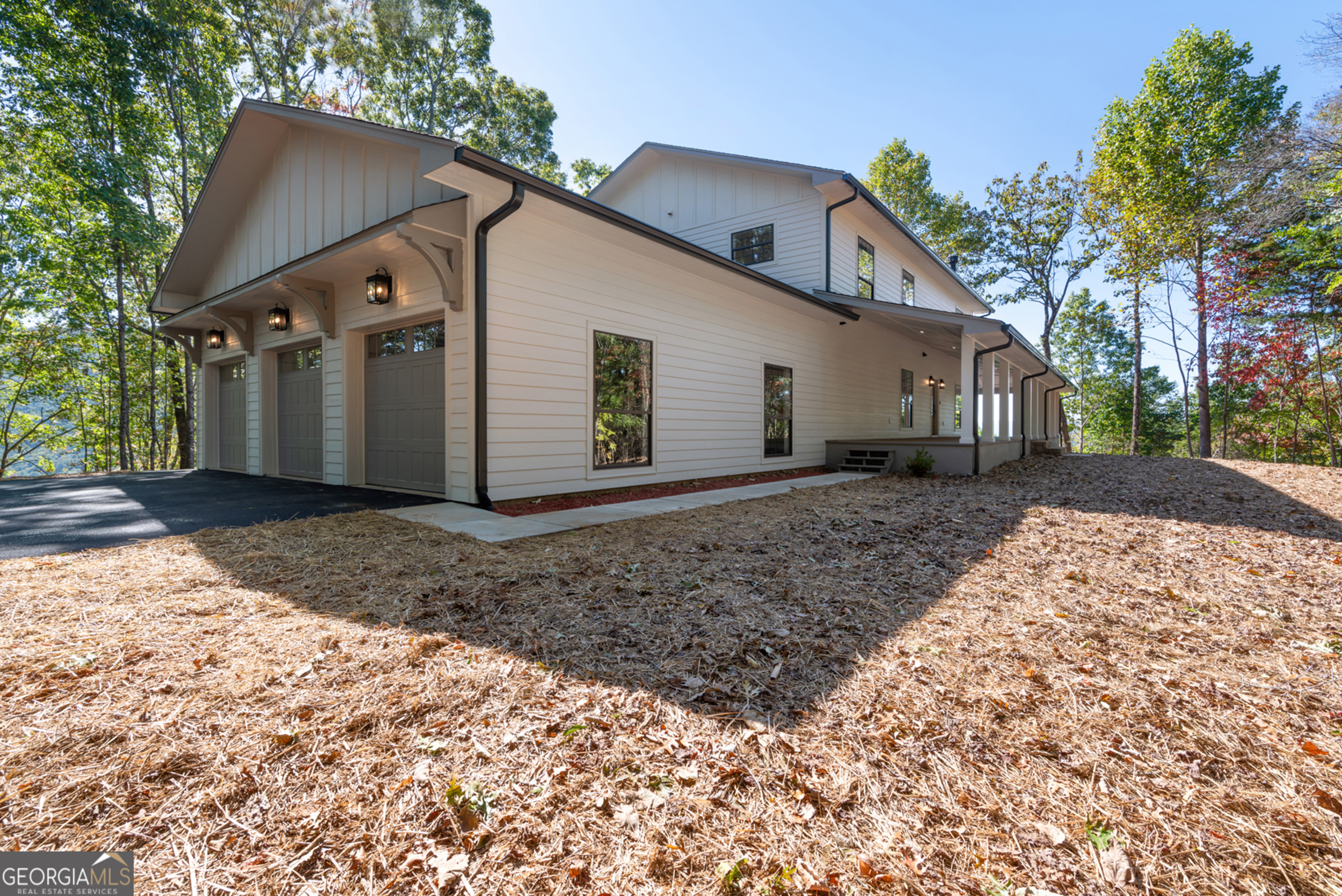 Experience breathtaking mountain views from this high-end custom, fully renovated home with almost 6,000 sq ft of heated living space perched above downtown Clayton listed BELOW APPRAISED VALUE! Enjoy the convenient and easy access of this mountain top retreat along a fully paved road and newly paved driveway. An expansive covered wrap-around deck invites you to sit outside and enjoy the long range mountain views nestled in a private, wooded setting. Step off your porch into a fully equipped kitchen which features a large island with custom wood cabinets, granite countertops, and new stainless steel appliances. Cozy up by the fireplace just off your open-concept kitchen. From the kitchen you enter a large sun room with plenty of light perfectly suited as a dining room as well as a sitting room/second living room. Enter the master-on-main bedroom which includes a private bath, jacuzzi tub, and huge walk-in closet. Walk upstairs to a spacious second floor which has a large loft area with ample space for a tv or reading nook, play area, or office. There is an additional master suite which boasts a gas fireplace, large walk-in closet, a luxurious bathroom and long range mountain views. Two additional bedrooms and a bathroom complete this spacious and bright second level. Head downstairs to the large basement which is the perfect space for a movie theater, shop, entertainment area, or workout room. The large and open space would also allow for a perfect mother-in-law or guest suite with a bathroom which can be accessed from a private entrance off the garage. The basement can be customized to your specifications to allow for the dream living space you desire! A three car garage proves ample parking, with additional storage space for a boat, RV, or a storage shed. This property offers the tranquillity and privacy of the mountains with the convenience of downtown Clayton less than 2 miles away where there is farm-to-table dining, boutique shopping, award winning restaurants and endless outdoor activities as well as Lakes Burton and Rabun nearby and under two hours from Atlanta. Located within the city of Clayton, this property could also immediately become a VRBO for additional income. Don't hassle with building- move right in to your dream home. The mountains are calling!