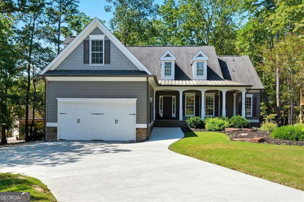 Welcome to 102 Eagle Heart Court, a beautifully upgraded custom-built 4-bedroom, 2.5-bathroom home offering comfort and energy efficiency. This thoughtfully maintained property features a whole-house generator, a buried propane tank, and a tankless water heater-providing energy savings. This home has been meticulously maintained and cared for inside and out. Inside, you'll find a comfortable master suite on the main floor complete with a cozy sitting area and tray ceilings, his-and-hers closets with custom closet systems to utilize space and organization. The primary bathroom offers a luxurious jetted tub and tiled shower. The house has been updated with modern, but classic light fixtures. You will love the ventless gas fireplace and beautiful hearth in the living room with impressive 14-foot ceilings--truly the heart of the home. The kitchen features an updated deep composite sink, touchless faucet, a functional pantry, and upgraded appliances including a GE Cafe dual fuel oven/range with the options of 6 burners or 4 burners with a cast iron griddle. The upstairs bedroom which can also be used as a flex space includes an en-suite half bath-which is also perfect for a home office, gym, media room, craft room, or guest area. You will love the laundry/mudroom on the main floor. The garage has painted epoxy floors. Three workbenches will stay with the home along with a flow wall in the garage for extra convenience, organization, and utility. The basement offers so much--including a built-in safe room! Basement is framed for a living room/media room, laundry room, full kitchen, full bathroom, and 3 additional bedrooms. With four new outlets already installed downstairs, the groundwork is set for your customization. Tech lovers will appreciate the hardwired Ethernet setup in the 4th bedroom/upstairs flex space. The home is constructed with durable 2x6 framing for added stability, increased structural strength, and superior energy efficiency. HVAC unit is newer and has been diligently maintained. Beyond the home's careful upkeep, you can feel secure knowing your new property is covered by a wildlife exclusion guarantee and a metal ridge vent to prevent pest intrusion. All potential entry points have been professionally sealed, ensuring a critter-free environment and saving you from costly future repairs. Enjoy the outdoors with two spacious decks and an incredible screened-in porch overlooking the private wooded lot. A brand-new driveway (just 8 months old) reinforced with rebar enhances curb appeal, while the side driveway includes an RV receptacle-ideal for travelers or guests. Additional features include new gutters and gutter guards, a radon mitigation system, a termite bond, and added attic insulation for long-term comfort. Completing the home is a stunning custom front door with textured glass, creating a warm and inviting first impression. For additional peace of mind this home is pre-wired for a security system. Lake Arrowhead features a 540-acre lake surrounded by mountains, pristine wilderness and miles of trails, along with championship golf. With over 20 miles of magnificent shoreline, Lake Arrowhead's crystal-clear waters boast depths over 80 feet and always remain at a constant level. Being ranked as one of the cleanest lakes in the state, this stream-fed lake is ideal for boating, fishing, swimming, as well as picnicking at the Marina's Lakeside Park. The 18-hole championship Highlands Golf Course is considered one of the best golf courses in Georgia. Other amenities include the Highlands Grill located in the clubhouse, 2 pools, tennis, pickleball, and volleyball courts, Lake Chickasaw, community docks, and Great Festival Park which has a playground, sidewalks, and a dog park. Blending modern updates with smart features and room to grow, this home is truly a rare find. Don't miss your chance to make 102 Eagle Heart Court your own private mountain retreat!