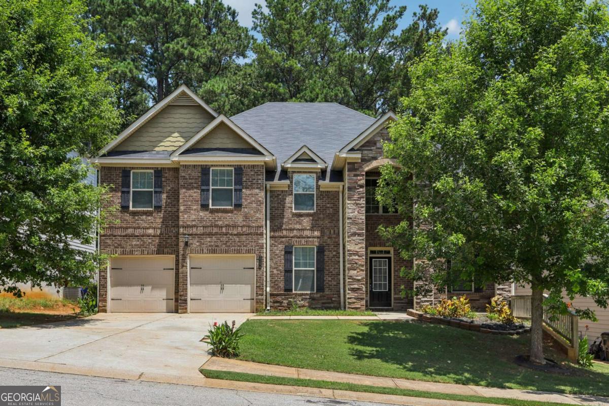 Brick Beauty in the Heart of Fairburn! Over 4,200 Sq Ft of Impressive Living Space Welcome to this stunning 5-bedroom, 4-bathroom brick home that truly has it all. From the moment you step into the dramatic two-story foyer, you'll be captivated by the spacious, light-filled layout and elegant design. Perfect for both everyday living and entertaining, the open floorplan features a formal dining room, a spacious family room, and a chef-inspired kitchen that flows effortlessly to the covered patio-ideal for relaxing or hosting guests year-round. Retreat upstairs to the oversized primary suite, complete with a private sitting room, perfect for unwinding after a long day. A large bedroom and full bath on the main level offer flexibility for guests or multigenerational living. Located in sought-after Fairburn, this home offers space, comfort, and style in one perfect package. You truly have to see it to believe it!