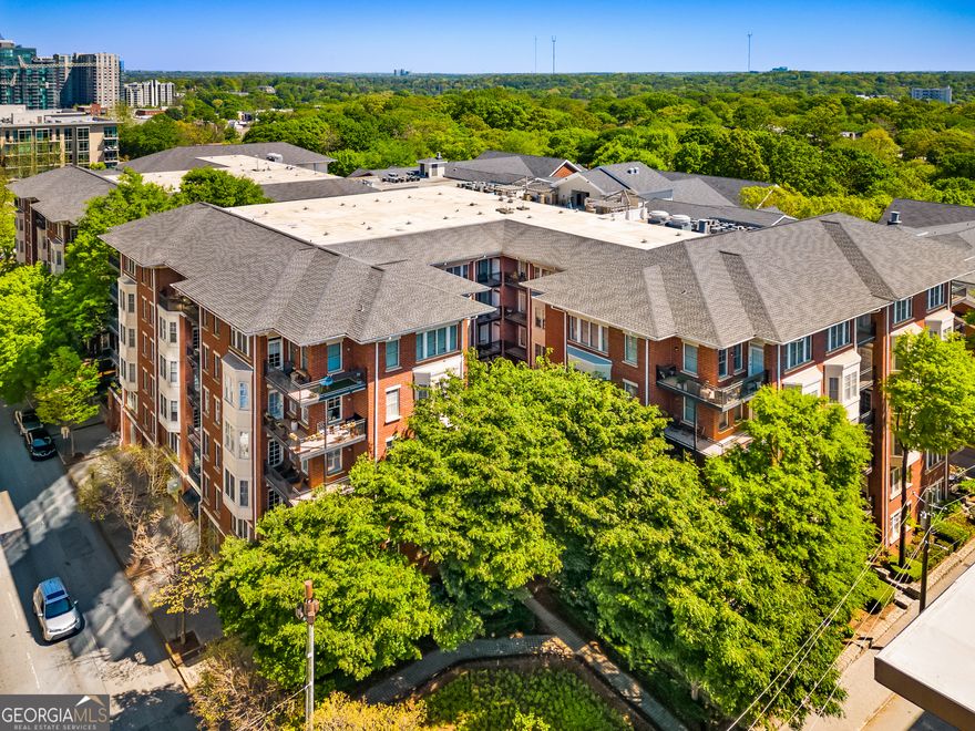 Fabulous New Listing at The Iconic Dakota!    This beautifully appointed 2-bedroom, 2-bath residence offers timeless Midtown living at its best. The spacious primary suite features a double vanity, separate glass shower, soaking tub, and a large walk-in closet. The inviting living room centers around a handsome fireplace and opens to the dining area, creating an ideal flow for everyday living and entertaining.    Enjoy morning coffee or evening cocktails on one of two private balconies overlooking the peaceful courtyard - one off the living room and another off the primary bedroom.    Convenience is key here: two gated, deeded parking spaces are located near the unit, as are the building's resort-style amenities, including a rooftop pool and sundeck with sweeping Midtown views, plus a fully equipped fitness center.    Perfectly positioned between the Garden District and Midtown's thriving business core, The Dakota offers a rare blend of urban excitement and lush tranquility. Step outside to explore Peachtree Street's shopping, dining, and nightlife - or take a quick stroll to Piedmont Park, the BeltLine, the Botanical Gardens, the Fox Theatre, or The High Museum.    Midtown living doesn't get better than this - goodness in every direction!