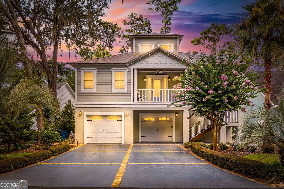 This custom-designed dream home offers the perfect blend of elegance, comfort, and functionality. Featuring 3 spacious bedrooms and 3.5 baths, the home boasts beautiful hardwood floors throughout the main living areas, adding warmth and sophistication. The chef's kitchen is outfitted with premium granite countertops, European maple cabinetry, and stainless-steel appliances-including a separate gas cooktop. A generous prep island, breakfast bar, breakfast area, and walk-in pantry complete the ideal kitchen layout. The inviting living area includes a wood-burning brick fireplace and expansive glass windows that provide serene views of the 7th hole of the King and Prince Golf Course. A custom spiral staircase leads to a loft/flex space, offering endless possibilities for a home office, library, or additional bedroom. The luxurious primary bathroom features a classic claw-foot tub, large walk-in showers, and custom cabinetry for a spa-like experience. Downstairs, the massive garage provides ample parking and houses a game room, while a full bedroom and bath on the lower level create the perfect private guest suite. An elevator services all levels of the home for added convenience. Outdoor living is elevated with multiple balconies overlooking the golf course, Hardiplank siding for durability, low-maintenance aluminum railings, and a metal roof that combines style with longevity.