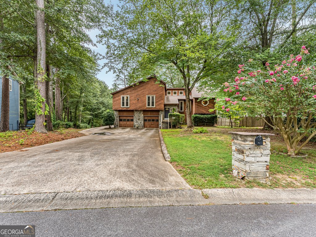 Welcome to this one-of-a-kind rustic-style home located at 2625 Deerfield Circle SW in Marietta. This charming property offers 3 bedrooms and 3 full bathrooms, combining warmth, character, and modern updates throughout. The inviting living room features a cozy gas fireplace, creating the perfect space for relaxing or entertaining. The kitchen is designed with stainless steel appliances, white cabinetry, and sleek black granite countertops, and offers direct access to the deck, making indoor-to-outdoor living seamless. The fully finished basement is a true extension of the home, complete with a wet bar, a dedicated office space, and walk-out access to a screened-in porch overlooking the backyard. Outdoor living is equally impressive with a large deck featuring stairs to the yard, a private backyard surrounded by mature trees, and a custom fire pit accented with post lighting for evening gatherings. Car enthusiasts and hobbyists alike will appreciate the oversized two-car garage with abundant storage and enough space to accommodate more than six vehicles on the driveway. **NO HOA** With its unique rustic architecture, ample living space, and thoughtfully designed outdoor areas, this home offers both charm and functionality. Conveniently located near restaurants, shopping and easy commute to I75, Smyrna, Kennesaw & Hiram. Less than 25 minutes from Dobbins Air Reserve Base. Less than 45 Minutes from Atlanta International Airport. Don't miss your chance to make this Marietta gem your own.