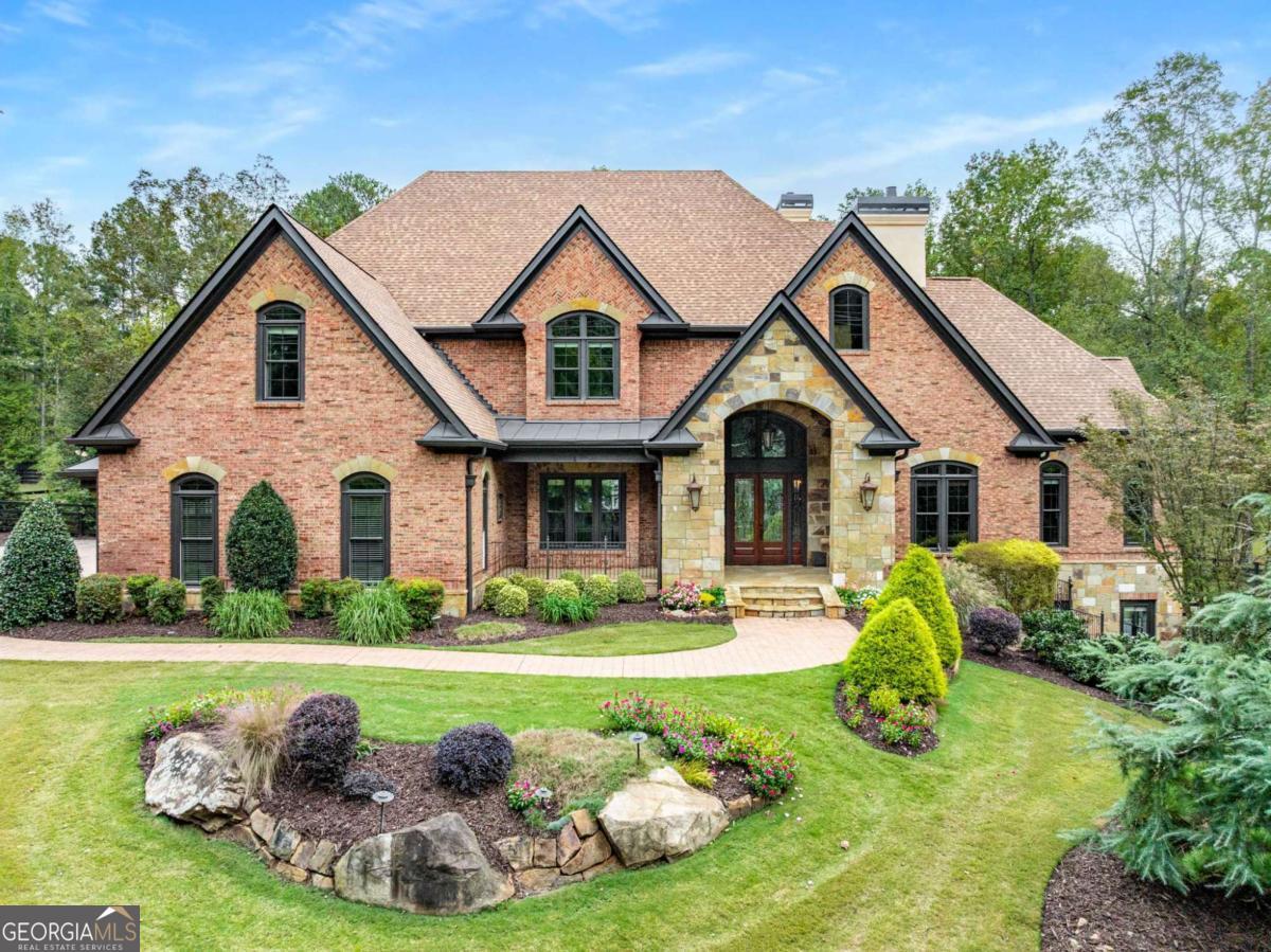 Experience timeless sophistication and modern convenience in this extraordinary gated estate in the heart of Milton, Georgia - where luxury, privacy, and multi-generational living come together seamlessly. Perfectly positioned and over 10k sq. ft. the property is located on a flat, fully fenced 2-acre lot with NO HOA restrictions. This impressive custom-built residence was originally designed by a custom homebuilder as their personal retreat. Every detail reflects craftsmanship, quality, and an enduring sense of grandeur. Thoughtfully refreshed for today's buyer with a NEW roof, all NEW windows, (3) NEW HVAC systems, fresh exterior paint, refinished hardwoods, repolished marble foyer, and expanded rear patio with extensive architectural landscaping and lighting, this estate offers both immediate comfort and long-term value - listed under appraised value for an exceptional opportunity and instant equity. Enter through one of two gated entrances: the main gate leading to a side-entry 3-car garage with newly epoxied floors and a rear workshop, or the secondary gate leading to terrace-level entry and RV parking with electric hookup and grey water station. Professionally landscaped grounds are irrigated by a private well and offer limitless potential for your dream outdoor oasis - whether it's a resort-style pool, tennis or pickleball courts, outdoor kitchen, putting green, or a lush garden retreat. Step into the two-story marble foyer, where a floating curved staircase sets an unforgettable tone. The formal dining room with butler's pantry is perfect for entertaining, while the handsome gentleman's office features alder-wood paneling, custom built-ins, and a limestone fireplace - with a discreet wet bar connecting directly to the main-level primary suite. The heart of the home centers around a soaring two-story great room with a limestone fireplace, flowing effortlessly into the chef's kitchen - outfitted with custom cabinetry, Dacor 6-burner range, dual ovens, commercial-grade refrigerator/freezer, and a grand stone-topped island. The adjoining keeping room with its own fireplace and generous breakfast area provides an inviting space for everyday living. Three Expansive Primary Suites - Ideal for Multi-Generational Living Each level features its own private primary suite, offering unmatched flexibility for extended family, guests, or live-in staff: Main-Level Primary Suite: Spa-like retreat with jetted tub, dual vanities, towel warmer, walk-in shower, and custom his-and-hers closets. Upper-Level Primary Suite: Elevated privacy with stone and tile finishes, a spacious walk-in closet, and towel-warming drawer. Terrace-Level Primary Suite: Light-filled and expansive, perfect for in-laws, guests, an au pair or adult child - complete with ensuite bath and the home's largest walk-in closet. Accessible via elevator to all three levels, the terrace level is a true entertainer's haven featuring a custom wet bar, double-sided fireplace, family and rec rooms, fitness area, home theater space, and multiple storage areas, with walk-out access to the secondary gated entry. Enjoy the freedom of no HOA and the prestige of living in one of Milton's most desirable addresses - surrounded by top-rated schools, world-class golf, equestrian estates, and upscale shopping and dining at Avalon, Halcyon, and Downtown Crabapple - all just minutes away. This property offers the best of both worlds: serene estate living and convenient access to North Metro Atlanta's finest amenities. Whether you're seeking a multi-generational compound, a private family retreat, or a luxury residence with endless possibilities, this home delivers. This is more than a home - it's a legacy. Schedule your private tour of Thompson Road today!