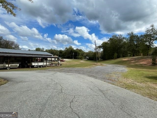 The possibilities are endless! Zoned C-4 on 4.48 acres with 5 access points. Currrently used as residential, home could be converted to office space. Located next to Exxon and Dollar General. Great for possible car wash, hotel, and much more!