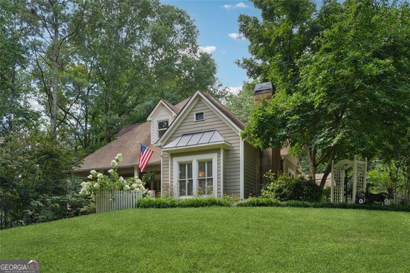 Escape to your own private haven in the heart of Hickory Flat! Nestled on over an acre of lush trees, this breathtaking home greets you with a charming rocking chair front porch, perfect for sipping sweet tea and soaking in the serene surroundings. Inside, rich hardwoods a two-story foyer and a bright neutral palette create an inviting glow. You're led to a stunning living room where a cozy fireplace with a striking wood mantle sets the stage for warm gatherings or quiet evenings. The modern kitchen is a showstopper, boasting a vibrant backsplash, sleek Quartz counters, bar seating, and its own fireplace-ideal for crafting culinary delights or hosting lively brunches. A charming breakfast nook overlooks the expansive backyard, offering a peaceful spot to start your day. Retreat to the spacious owner's suite, a true sanctuary with a spa-like ensuite featuring a soaking tub, double vanities, and a walk-in shower that promises pure relaxation. Four generous secondary bedrooms provide ample space for family or guests, while an upstairs loft beckons as the perfect play area or movie night hideaway. The full finished basement elevates this home with a bedroom, bathroom, kitchenette, and laundry hookups-ideal for visitors or versatile living. Step outside to an outdoor paradise, where a large deck with a pergola, tranquil pond, and inviting fire pit create a magical setting for summer barbecues or starry nights. Zoned for top-rated Creekview High School and a short drive from the vibrant charm of downtown Milton and Woodstock. Enjoy easy access to local parks and shopping off Hickory Flat. Schedule your showing today and claim the idyllic Woodstock lifestyle you've always dreamed of!