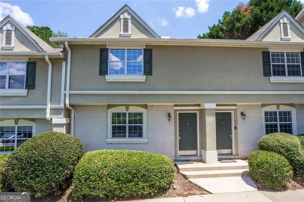 Fabulous, Gated Sandy Springs location! Clubhouse, workout room and pool! Kitchen with granite and ss appliances, tile floors in baths, , neutral paint throughout. Hardwood floors on main and steps, laminate hardwoods upstairs on bedroom level. No carpet! Perfect roommate plan with private bath and walk-in closets in each suite! Walled patio through french doors from dining area provides view of grass and trees. Assigned parking. Act now, it won't last long!