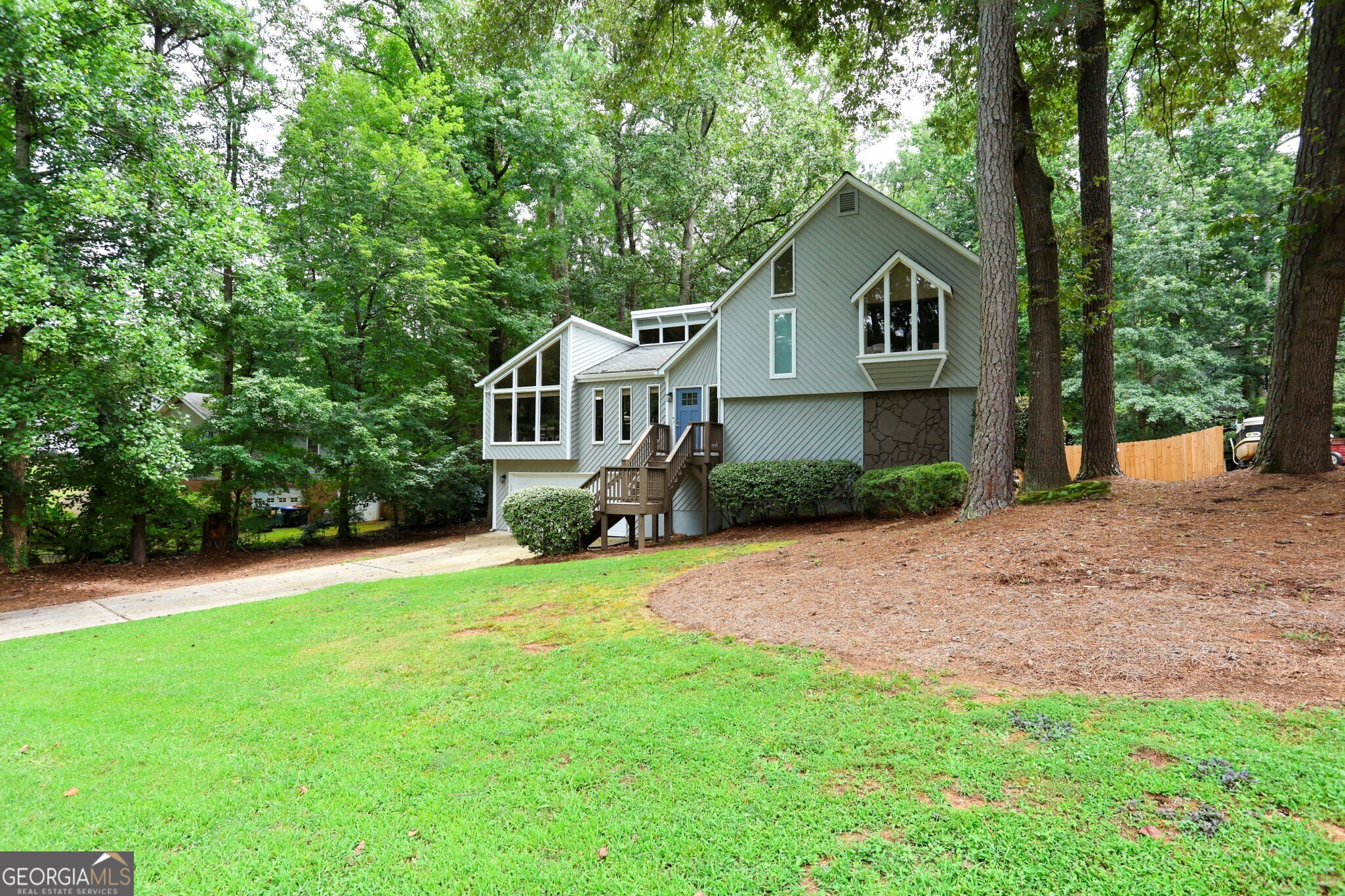 Nestled in the heart of East Cobb's desirable Liberty Ridge subdivision, this traditional style home beautifully blends timeless curb appeal with modern updates. It offers 4 bedrooms, 3 full baths and approximately 2,266 square feet of thoughtfully finished living space. The vaulted ceiling great room, anchored by a granite fireplace, creates a welcoming ambiance perfect for both family living and entertaining. The bright, open kitchen delights with white cabinetry, granite countertops and tile backsplash. Hosting is effortless with two private rear decks and built-in fire pit, while the basement offers a versatile daylight suite ideal for teens or extended family. Conveniently located near shopping, parks and the best of East Cobb.