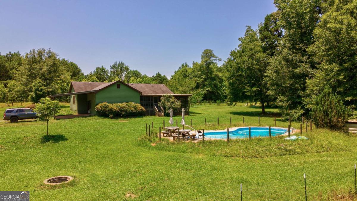 Southern Land Exchange is proud to present a 1828 Pitts Chapel Road, the perfect property for someone looking for house and acreage in the Jasper County area. The house is just over 2,000 sqft and sits on 19.27 acres. This property is very private and has about a 1,000 ft long driveway with deeded frontage on Pitts Chapel Road. With fenced pasture and mature pines and hardwoods, this property offers the best of both worlds. There is also 550 ft of a blue-line tributary off Pittman Branch near the back of the property with both sides of the stream on the subject property. In addition to the primary home, there are multiple other usable structures that provide value to the property, such as pole barns for storage. Did a mention it has an in-ground swimming pool! Located near the Jasper-Newton County line, the property is less than 20 minutes from Monticello and less than 30 minutes from Covington. Also located near the Morgan County line, the property is only 20 minutes to I-20 and 25 minutes to Madison, GA. Your small farm adventure awaits! Call Travis Ebbert at 706-614-8840 for more information.