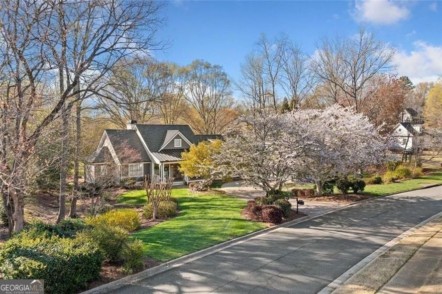 This move-in ready Ranch in Bradshaw Farm brings together updated interiors, a full in-law suite, nearly an acre of land bordered by two creeks providing unmatched privacy, and a location that puts golf, pools, tennis, and more just a short walk or cart ride away. With a newer roof, new HVAC, 2 water heaters, tankless and a brand new 50 gallon water heater, whole-house water filtration system, and even a FEMA-approved storm shelter, it's a rare mix of charm, function, and peace of mind.  Step through the front porch into a bright, open floor plan with refinished hardwoods and updated lighting throughout. The main living space features a vaulted ceiling, built-ins, and a gas fireplace framed by a classic wood mantel. The fully renovated kitchen includes quartz countertops, shaker cabinetry, stainless steel appliances, and a custom farmhouse sink, flowing into a wet bar with natural light all around. Just off the kitchen, the screened porch and large back deck invite you to relax and listen to the creeks running along both sides of the property.  The primary suite is privately situated and features a spa-inspired bathroom with a freestanding soaking tub, marble tile shower, and dual closets-one of which serves as a reinforced storm shelter. Private office or flex room just off primary suite. Two additional bedrooms and renovated Jack and Jill bath with an additional freestanding tub and separate shower featuring handmade Spanish tile complete the main level, offering flexibility for guests or workspace.  Over the oversized detached garage, a full in-law suite adds a fourth bedroom or living area, kitchen, and bath with a separate entrance-ideal for visitors or extended stays.  Outdoors, the flat, landscaped yard offers space to play, garden, or entertain. In Bradshaw Farm, you'll also enjoy access to golf, multiple pools, tennis courts, pickleball, volleyball, basketball, a clubhouse, and playground-all in one of Woodstock's most sought-after neighborhoods.