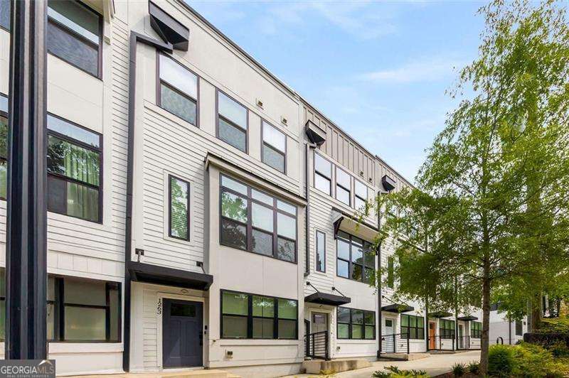 Modern Living in the Heart of East Atlanta Village! Just steps from the vibrant core of East Atlanta Village, this stylish contemporary townhome places you in one of Atlanta's most energetic and walkable neighborhoods-surrounded by beloved local restaurants, shops, and the weekly farmers market. Inside, sleek modern design meets effortless functionality. Soaring ceilings and oversized windows fill every space with natural light, while thoughtful finishes add a refined touch throughout. The entry level features a flexible bonus room-perfect as a home office, playroom, or potential 3rd bedroom-plus a convenient closet and foyer. Upstairs, the open-concept main floor is bright and inviting, ideal for both entertaining and everyday living. The showstopping kitchen boasts Quartz countertops, custom cabinetry, stainless steel appliances, a statement tile backsplash, built-in coffee bar, expansive island, and a full wall of windows that feels like art. A chic powder room completes the main floor. Upstairs, retreat to the sunlit primary suite with a spa-like ensuite bath featuring dual vanities and a frameless glass-tiled shower. A spacious secondary bedroom and full bath provide the perfect setup for guests, family, or a roommate. The crown jewel? Your private rooftop terrace-an outdoor oasis for grilling, lounging, or soaking in the skyline views year-round. A rare tandem two-car garage offers generous parking and storage-an exceptional find in this coveted area. Enjoy walkable access to Bellwood Coffee, Argosy, Banshee, Brownwood Park & Tennis Courts, and more. Plus, you're just minutes from the Southside BeltLine, connecting you to Inman Park, Grant Park, Midtown, and beyond. Don't miss this opportunity to own a turn-key, design-forward home in one of Atlanta's hottest neighborhoods. Welcome to vibrant living in EAV!