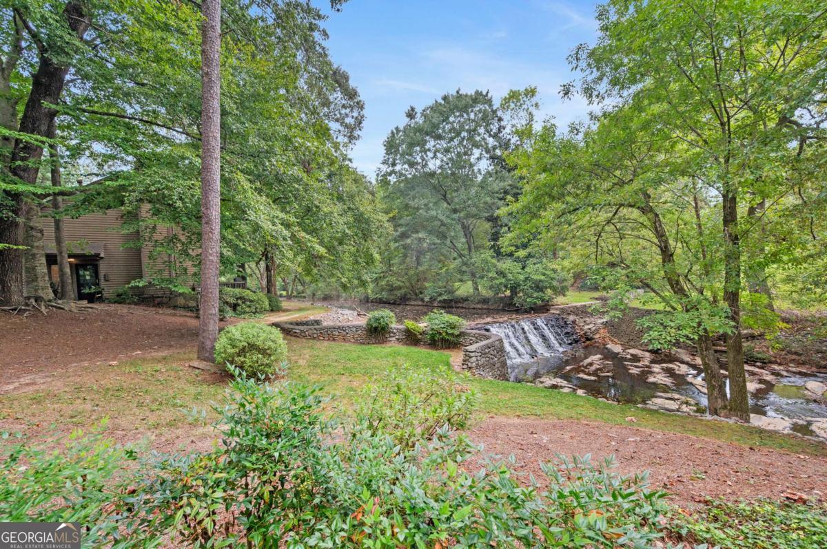 Welcome to D'Youville - Atlanta's Best-Kept Secret ITP!!! Nestled in a quiet, tree-lined community, this spacious townhome offers rare views of Nancy Creek from your back porch - a private retreat right inside the Perimeter. The main-level primary suite features a spa-like jetted tub, while upstairs boasts two large bedrooms and a flexible loft, perfect for a home office or creative space. Set in one of the most coveted locations in the neighborhood, you'll enjoy privacy, abundant green space, and three assigned parking spaces. D'Youville residents love the swim, tennis, and trails, all tucked within a protected nature preserve. Families benefit from highly rated schools, and everyone will appreciate unmatched convenience: just one mile from I-285 and minutes to GA-400, Perimeter Mall and Buckhead. With the HOA covering pool, tennis, water, sewer, and garbage, this hidden gem offers low-maintenance living in a safe, pet and kid friendly community. The perfect blend of nature, comfort, and location - Welcome Home!