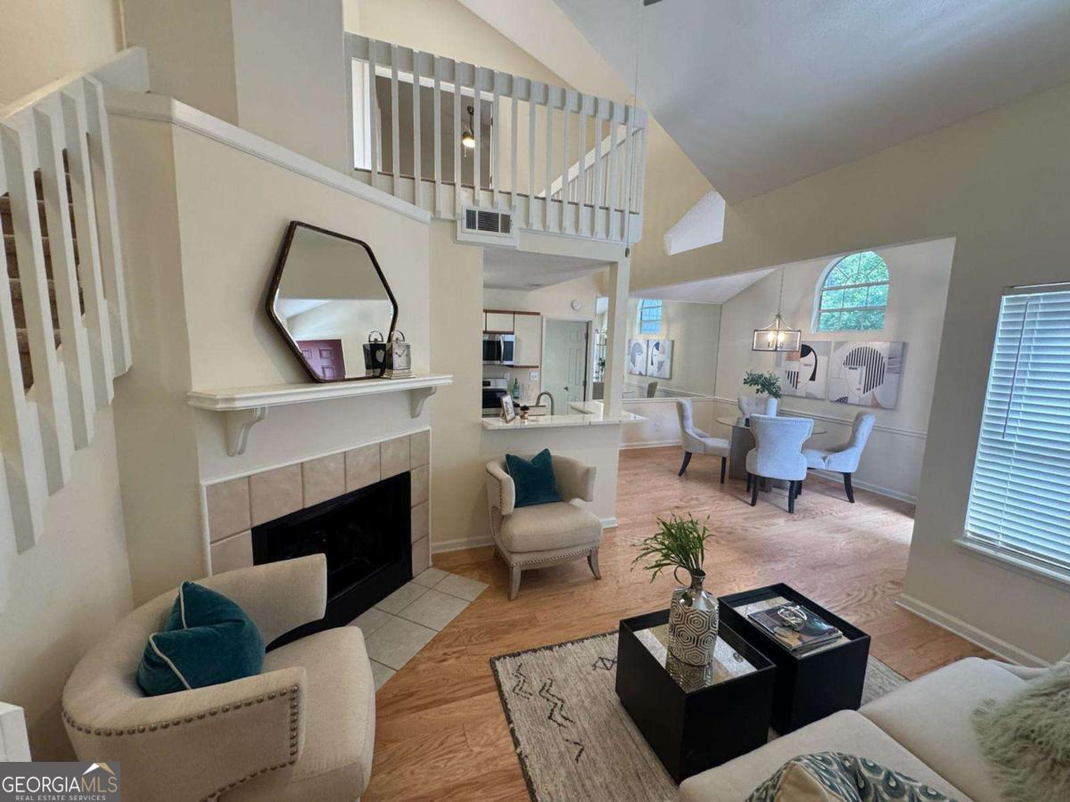 Beautifully renovated top-floor, end-unit condominium filled with natural light and located in a peaceful, wooded community near the Chattahoochee River and a 27-acre park. This spacious 2-bedroom, 2-bath with a bonus loft space, ideal for a home office featuring an open floor plan with soaring vaulted ceilings, skylight, and wood-burning fireplace. The main level boasts new hardwood floors, modern lighting, and updated hardware throughout. The kitchen is fully upgraded with quartz countertops, stained cabinetry, tile backsplash, and all new stainless steel appliances. A separate formal dining room and a light-filled breakfast area offer multiple options for entertaining. The primary suite features a vaulted ceiling, walk-in closet, and en-suite bath with a tub/shower combo. All bedrooms offer vaulted ceilings and walk-in closets. Enjoy the golf course view from the front porch, plus assigned parking and plenty of guest parking. The entire community is undergoing exterior upgrades with new cement siding. Residents also enjoy access to amenities including a pool, tennis courts, and over 20 acres of parkland with walking trails along the river. Conveniently located near shopping, dining, Historic Downtown Roswell, Alpharetta, Avalon, and The Forum.