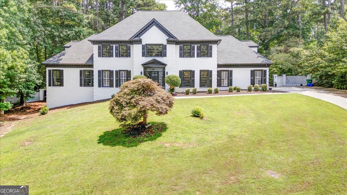 In a Golf Course Community, tucked into the tree-lined charm of Smoke Rise's Kanawha Hills, this home blends everyday comfort with elevated style. The white brick exterior paired with sleek black accents creates instant curb appeal, but it's what's inside that truly sets it apart. Step through the front door and into a space filled with natural light and thoughtful design. A dramatic staircase welcomes you into a layout that feels open, yet purposeful. At the center is a fully renovated kitchen, where quartz countertops, custom cabinetry, and high-end appliances come together to create a space that's as functional as it is beautiful. The kitchen flows easily into the breakfast area and family room, making it ideal for both casual mornings and lively evenings. The main-level primary suite offers a calm retreat, featuring a spa-inspired bath with a soaking tub, frameless glass shower, LED mirrors, and a walk-in closet designed with everyday luxury in mind. Upstairs, each secondary bedroom brings comfort and privacy, while smart design details throughout the home make every space feel intentional. The fully finished terrace level opens up even more possibilities. Whether you're hosting guests, working from home, or enjoying movie nights, you'll find everything you need-including a second kitchen, soundproof studio, media room, and polished epoxy floors. Out back, the private yard becomes your personal getaway. A resurfaced pool, hot tub, waterfall feature, and flagstone patio are framed by mature trees, offering peace, privacy, and the perfect setting for entertaining. Located within walking distance to community favorites like tennis courts, playgrounds, scenic trails, and a prestigious golf course, this home delivers the best of neighborhood living with room to relax and recharge. Schedule a private tour today and experience the lifestyle that awaits. Kristen Johnson Real Estate is ready to help you make it yours.