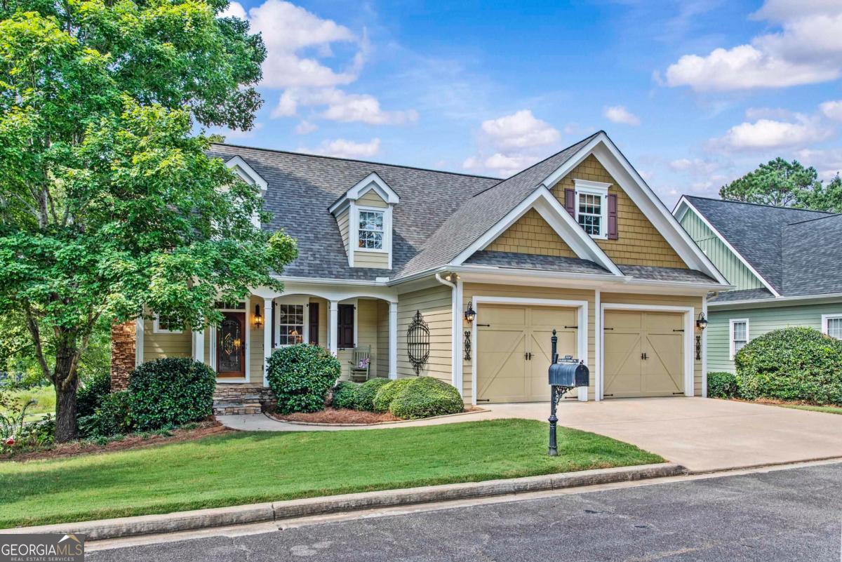 Welcome to your new home, 1170 Harbor Ridge Drive. This 4-bedroom, 3.5-bath home is perfectly positioned with views of the 16th, 17th, and 18th holes of Harbor Club's award-winning Weiskopf-designed golf course-one of Georgia's top-rated. With sweeping views of both the course and beautiful Lake Oconee, this residence blends convenience, location and lifestyle into one beautiful home. Inside, you'll find approximately 4,000 square feet of thoughtfully renovated living space. The main floor features seamless flow between the living room, dining area, kitchen, and a light-filled sunroom-the ideal spot to relax while soaking in serene golf and lake vistas. The private owner's suite offers its own retreat with breathtaking views, a spa-like en-suite bath, walk-in shower, and generous walk-in closet. Upstairs, two bedrooms and a versatile loft/office share a convenient bath-perfect for family or guests. The finished terrace level provides even more space to entertain, complete with a second living/media room, wet bar, additional guest suite and a patio overlooking the golf course and lake. Beyond the home, the location couldn't be better. Walk to the pool, tennis courts, and clubhouse, or take a short drive to the fitness center, pickleball courts, and the Boathouse Restaurant.