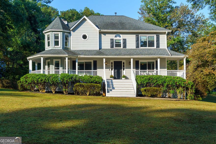 Sellers have found their next home and are offering this property at a fantastic value-don't miss out!  Seller providing 2 Year Home Warranty.  Welcome to 4941 Willow Lane - 4BR/2BA + 2 half-bath traditional Colonial in the Willow Creek Community, Marietta side.  Minutes from Downtown Woodstock's prime shopping, dining and entertainment.  Set on a large corner lot, this home features a wrap-around rocking chair porch, hardwood and vinyl plank floors throughout, and a spacious family room with fireplace. The large kitchen offers granite counters, stainless appliances, breakfast bar, and pantry. Owner's suite includes relaxing fireplace, trey ceiling, dual vanities, jetted tub, and walk-in closet. Finished basement with inside/outside entry provides great flex space for additional entertaining space, media room, playroom or guest suite. Outside, enjoy the deck, fire-pit area, and fenced yard. Updates include new front steps, new flooring in owner's suite and lower level.  Active swim/tennis community w/2 pools.  Top Cobb County Schools.