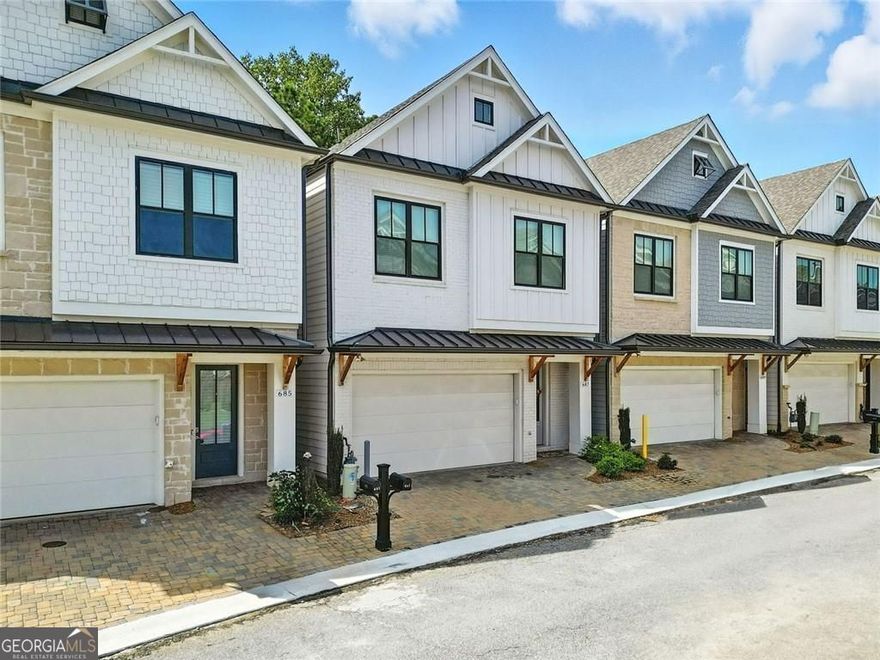 Get a 1/0 rate buy-down for the first year using the Seller's preferred lender! Built in 2023, this clean-lined, modern home delivers standout features from the start. The exterior combines vertical board-and-batten siding, black-trim windows, and natural wood accents that bring warmth and character. Inside, the open-concept layout is bright, functional, and ready for both everyday life and entertaining. At the center of it all, the kitchen makes a strong impression, featuring quartz countertops, a large island with seating, soft-close white cabinetry, and a stainless steel gas cooktop with a statement vent hood. A walk-in pantry, built-in wall oven, and under-cabinet lighting complete the polished look. The open living and dining areas flow together with high ceilings and hardwood floors throughout. Just out back, enjoy two outdoor living options: a ground-level patio perfect for grilling and a private upper deck with access directly from the primary suite. The primary bedroom retreat includes a spa-style bath with a large walk-in shower, double vanity, and a spacious walk-in closet with built-in shelving and storage, keeping everything organized and easy to access. Upstairs offers two more bedrooms, a full bath, and laundry, all tucked into a well-planned layout. Located in a gated community with amenities that include a pool, clubhouse with gym, fire pit, tennis/pickleball courts and three dog parks within the gated areas. Just minutes to Downtown Woodstock's shops, restaurants, and local events.
