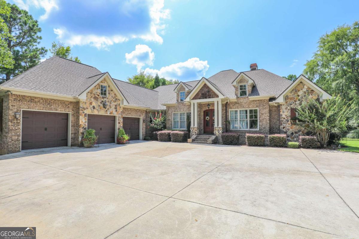 Come see this gorgeous home located within the gates of the Greystone Arbor subdivision! This home boasts five bedrooms, five and a half bathrooms, and two bonus rooms that could easily be additional bedrooms. Whether you are dreaming of a home theater, an office space, or the coolest play room in town, there is plenty of space to make it happen! The kitchen is stunning and complete with solid surface counter tops, stainless steel appliances, and a large island. There is a keeping room with a cozy fireplace off of the kitchen perfect for entertaining. The main living room is a show stopper full of natural light, built in book cases, a stone fireplace, and coffered ceilings. The primary bedroom is beautiful! It has tray ceilings, a light-filled seating area, and a large bathroom with tile floors, bathtub, and shower. Two additional bedrooms also have in-suite bathrooms. The back yard has everything you need to dazzle your guests and entertain your family! The private backyard holds a large, in-ground pool that is complimented with a complete outdoor kitchen, fireplace, covered porch, patio area, and a half bathroom. A well-established garden is ready for you to embrace your green thumb! This home truly has something for everyone and it could be perfect for you and your family! Give us a call to see it today!