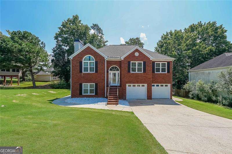 Welcome to the Home of Your Dreams in Woodstock! Step into a home that feels like it was built just for you - a place where every detail was designed with love, comfort, and connection in mind. With 5 spacious bedrooms and 3 full bathrooms, including a primary suite on the main level, this home blends functionality with elegance. The gourmet kitchen is a true centerpiece, boasting modern white cabinetry, designer tile backsplash, and top-of-the-line stainless steel appliances. It's more than just a kitchen - it's where your favorite moments will be made. The open-concept family room, featuring a custom fireplace, creates a warm and welcoming space for gathering. And when it's time to recharge, your luxurious master suite offers a spa-inspired walk-in shower and peaceful ambiance that turns everyday routines into rituals of self-care. Downstairs, discover a fully renovated in-law suite with a private entrance, full kitchen, and living area - perfect for extended family, guests, or even passive rental income. It's not just additional space - it's freedom, privacy, and opportunity under your roof. Outside, your private backyard is a sanctuary for connection and calm, perfect for barbecues, cozy evenings under the stars, or peaceful mornings with coffee and the sounds of birdsong. This home features solid hardwood floors throughout, a brand-new kitchen and bathrooms, and thoughtful upgrades that make it 100% move-in ready, so you can arrive... and begin your next chapter. And the location? Just minutes from downtown Woodstock, where you'll enjoy charming shops, dining, festivals, and a true sense of community. Top-rated schools and beautiful parks are also just around the corner, offering a lifestyle that's both vibrant and grounded. This isn't just a house - It's home. It's an opportunity. It's the life you've been waiting for. Schedule your private tour today and come feel what makes this home so special.