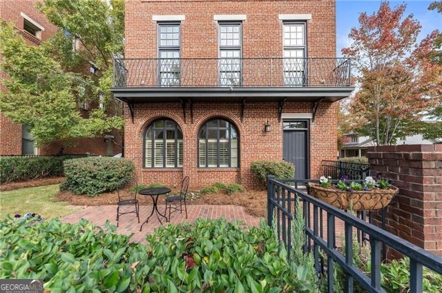 Welcome to the Crabapple lifestyle! This fabulous brownstone is one of the Crabapple Market District's original and most sought-after properties; these homes rarely go on the market. Fabulous community, well built home, and quite a value compared to the nearby new construction townhomes selling at nearly $1.5m! This detached home features 2 bedrooms, 2.5 bathrooms, large living spaces and a terrific loft/office space. Enter through the fenced front gate or rear-facing 2-car garage to the ground level with 2-story foyer, very large bedroom and full bath. Upstairs, the main level has 10+ foot ceilings and hardwood floors throughout. A gorgeous kitchen has been updated with honed Michaelangelo quartz countertops, new backsplash, and brand new gas range. The fireside great room features floor-to-ceiling windows with plantation shutters while on the other side of the kitchen there is a large dining room and keeping room. Upstairs is the oversized master suite, a loft/office with built in desk, and a separate laundry room. Master bath features double vanity, updated countertops, large soaking tub, separate walk-in shower and huge custom closet. Four-sides brick, this detached home means no shared walls. Roof is 3 years old, newer HVAC, water heater 2019. Fully fenced, garage has finished floor and $7500 of custom built-ins for additional storage. HOA of $625/quarter includes all yard maintenance.