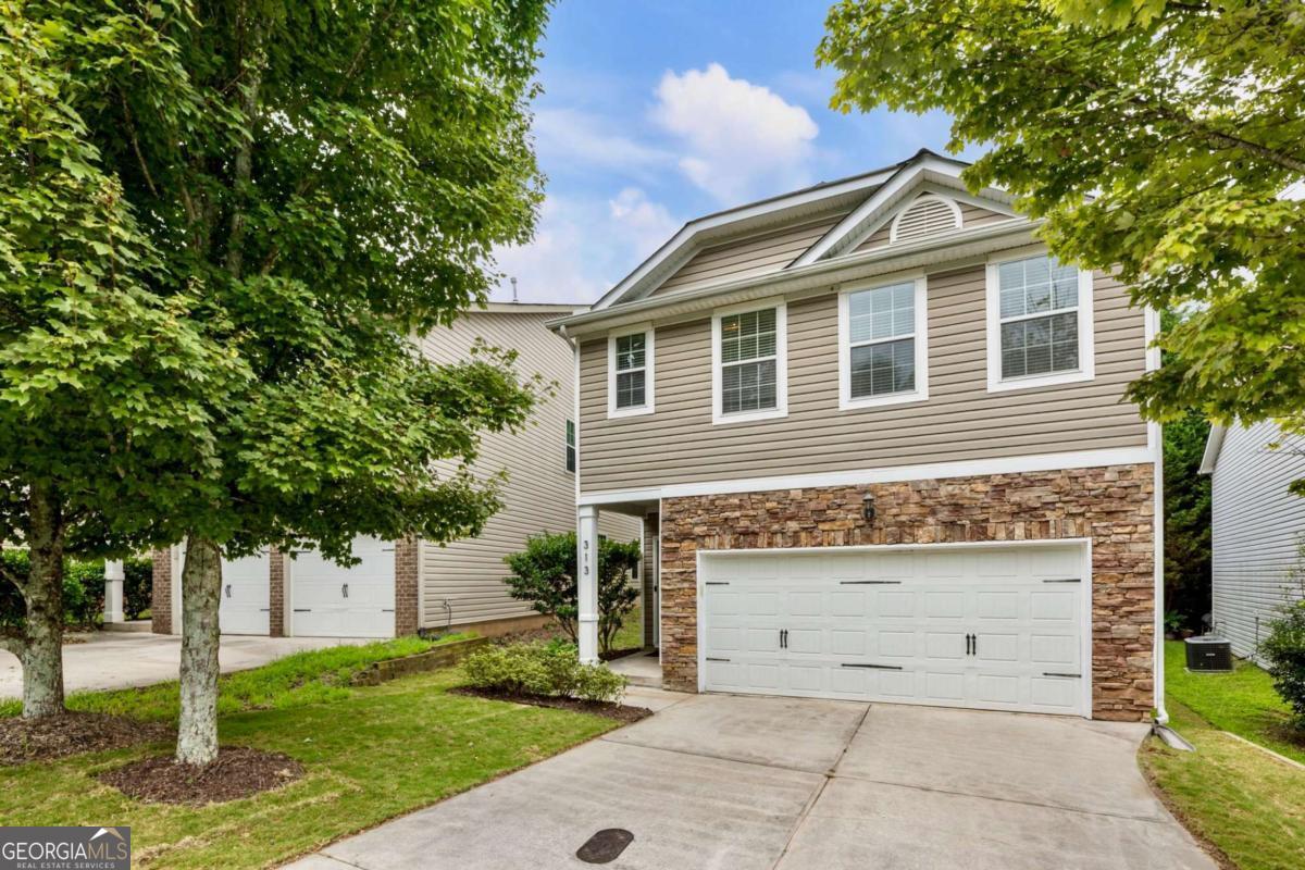 Charming, Move-In-Ready Home in Canton! Welcome to this beautifully maintained 4-bedroom, 2.5-bath home offering 2,400 sq. ft. of living space in the highly sought-after Hidden Creek community of Canton. Built in 2009, this move-in-ready home blends timeless design with modern comfort. The main level features a spacious open-concept layout with soaring ceilings, rich hardwood floors, and abundant natural light. At the heart of the home is the gourmet kitchen, complete with granite countertops, custom cabinetry, updated stainless steel appliances, an oversized pantry, and a breakfast bar that comfortably seats four. The kitchen flows seamlessly into a sun-filled breakfast room with views of the serene backyard and the inviting family room centered around a cozy fireplace. Step outside to a large Trex deck, perfect for al fresco dining or relaxing by the fire pit, all set against a tranquil, tree-lined backdrop. The main floor also includes an open-concept dining room and a powder room. Upstairs, the luxurious primary suite features a tray ceiling, a private sitting area, a spa-like bathroom, and a generous walk-in closet. Three additional bedrooms with vaulted ceilings, a full guest bath, a versatile loft (ideal for a study or home office), and a laundry room complete the upper level. Located minutes from Downtown Canton, I-575, award-winning schools, and Blankets Creek Mountain Bike Park, this home also benefits from a flexible HOA rental policy-offering both an exceptional lifestyle and an incredible investment opportunity.