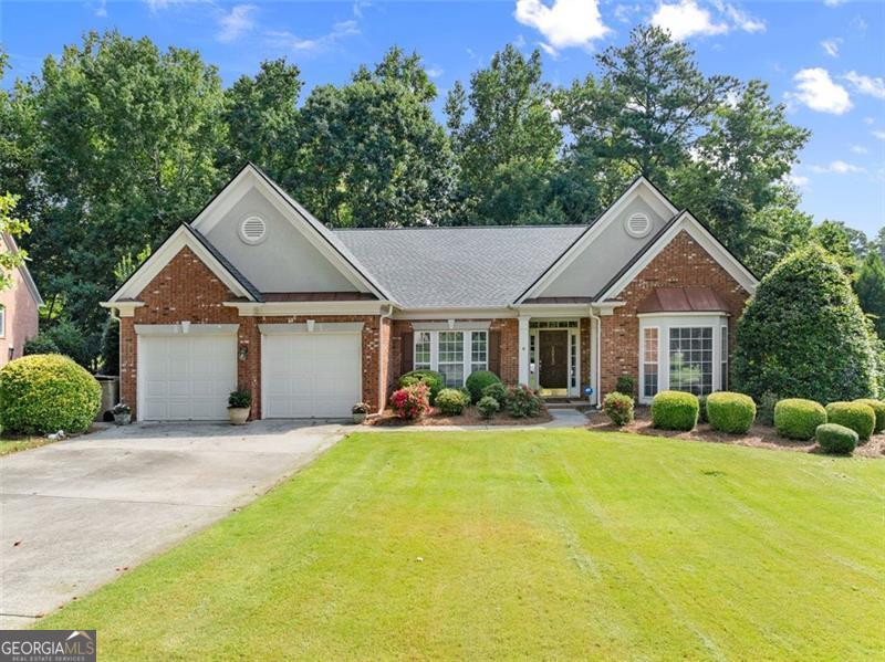 Discover this beautifully updated stepless ranch in the sought-after Commons section of Longlake! Located on a quiet cul-de-sac, this home sits on one of the neighborhood's larger, flat, fenced lots backing to a peaceful creek. Inside, you'll find new LVP flooring throughout most of the home, Nest thermostats, and a stunning kitchen featuring a beautiful island, walk-in pantry, and Electrolux appliances including a wall double oven and gas cooktop-perfect for everyday living and entertaining. The spacious family room offers an updated fireplace surround for cozy evenings at home. The master suite includes a walk-in closet with built-ins and a spa-like bath with Italian tile flooring. Step outside to a deck built to easily screen in for year-round enjoyment. A new roof adds peace of mind and lasting value. Enjoy Longlake's incredible lifestyle with a 45-acre lake, clubhouse, pool, tennis and pickleball courts, playground, and active swim, tennis, and pickleball teams-all in one of Forsyth County's most desirable communities!
