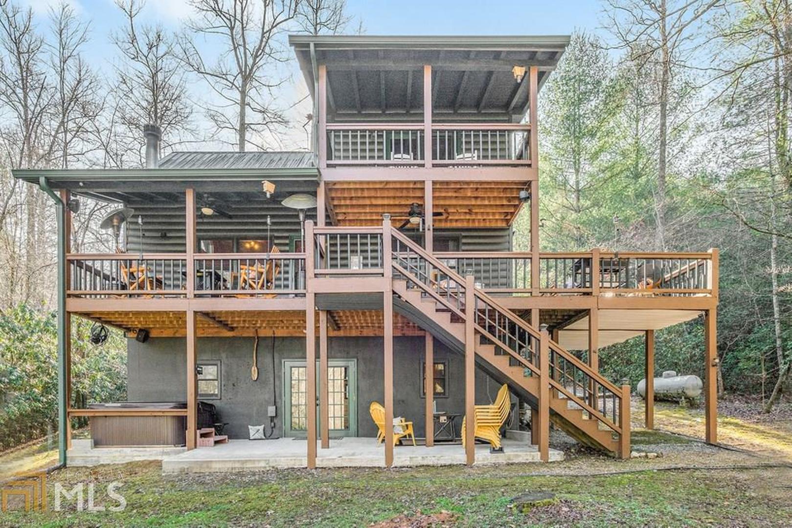 This cabin in the woods is magic! Escape for the weekend to your own private retreat complete w/ bocce court, horseshoe pit, rock firepit, stocked spring fed fish pond, private jogging loop & more. Attention to detail? Yes! You will find a beautifully updated 3BR 3BA cabin w/ gorgeous renovated chef's kitchen, granite countertops throughout, soaring cathedral ceilings, spacious master suite w/ private balcony, finished basement w/ game room, fully appointed wet bar & workshop. Did I mention the wrap around decking, concrete party pad w/ hot tub & enclosed storage shed? This one really has it all! Perfect full time home, Vacation cabin, or Rental
