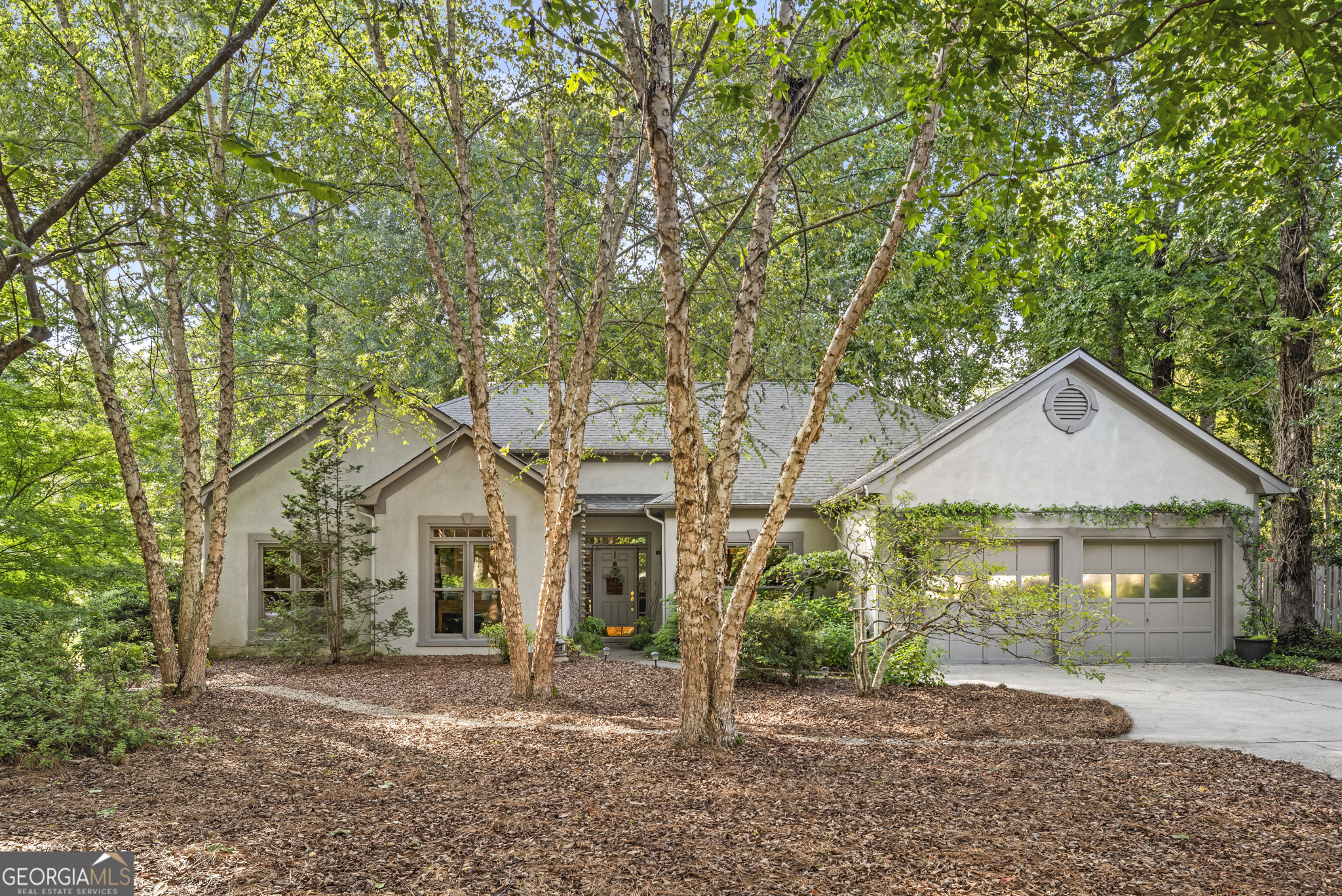 Welcome to this exquisite 3-bedroom, 2-bath ranch-style home that masterfully combines sophistication and comfort, spanning a well-laid-out 1,835 square feet. This meticulously maintained home is truly move-in ready, with a beautifully updated interior that promises a seamless living experience. As you step inside, the entrance greets you with a spacious sitting room, highlighted by a striking picture window. This feature invites ample natural light, offering captivating views of the lush outdoors. The dining room, located just to the right, leads into a chef's dream kitchen equipped with ample counter space and elegant glass-front cabinets, enhancing its modern aesthetic. Whether hosting a dinner party or enjoying a quiet meal, this culinary space is both functional and beautiful, including counter seating and a breakfast room for additional dining options. One of the home's most enchanting features is its all-windowed sunroom (not included in the square footage), offering a peaceful retreat overlooking a master gardener-curated backyard. The crown jewel is the backyard garden oasis - lovingly cultivated for over 15 years with mature plantings, winding paths, and multiple sitting areas designed for reflection, conversation, and entertaining. Whether enjoying morning coffee beneath the canopy of greenery, hosting friends in the dappled light of the garden, or simply taking in the serene views from indoors, this private retreat is truly irreplaceable. Don't miss this rare opportunity - a property with such an established garden sanctuary doesn't come on the market often. The living room, adorned with a cozy fireplace, ensures warmth during cooler months. To the left, two bedrooms share a hall bathroom, while the owner's suite offers additional access to the scenic backyard, featuring a large tiled updated shower, dual vanities, a soaking tub, and a walk-in closet. This rare offering epitomizes the sought-after lifestyle in this desirable community, with the ease of golf-cart living in the highly sought after Starrs Mill High School District. Don't miss your chance to view this home, which won't last long on the market. Please note, the seller will need a temporary occupancy agreement until October 31, 2025.