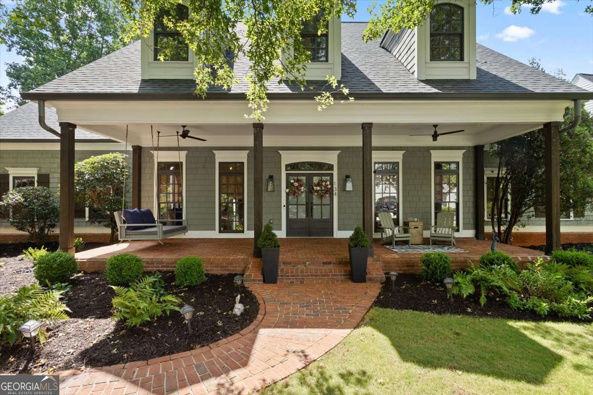 Discover your next luxurious residence, now available in the prestigious gated community of Achasta, perfectly nestled in the picturesque foothills of Dahlonega's majestic mountains! This impeccably renovated 5-bedroom, 4-full and 2-half bath Craftsman home defines sophisticated mountain living with unparalleled upgrades and refined finishes throughout. The grand main level features a spacious primary retreat with a spa-inspired bath, custom-designed closets, and private access to a covered patio overlooking serene wooded hillsides with incredible views from morning to night. The vaulted great room, anchored by a gas fireplace, flows into a renovated gourmet eat-in kitchen that seats eight, outfitted with granite countertops, premium stainless steel appliances including a double oven and separate gas cooktop and an adjacent formal dining room to host unforgettable dinner parties and lively celebrations. The main level also includes a large private office with French doors, while the main-level deck invites outdoor grilling and relaxation. Additional conveniences include a main-level laundry with a wash basin, a stylish half bath, and multiple pantries for storage. Upstairs, three generously sized bedrooms provide ample space for family and guests. One bedroom features a luxurious en-suite bath, while the other two share a well-appointed Jack-and-Jill bathroom. Included on the upper level is a versatile loft area perfect for a playroom, and access to unfinished attic space, which offers endless possibilities for customization. The expansive terrace level has been elegantly renovated and designed for multi-generational living or guest accommodations. It boasts a second gourmet kitchen featuring soft-close cabinetry, a spacious island with storage, granite countertops, and high-end stainless steel appliances, including a large gas range and oven. Enjoy a home gym, a custom bunkroom with built-in storage, a cozy den with a gas log fireplace, and a state-of-the-art Sonos home theater system paired with a 75-inch TV. This renovated level also features a spacious bedroom with an ensuite bath, walk-in closet, and abundant storage, complemented by a convenient washer/dryer setup and a mudroom with private entryway. Embrace year-round outdoor living on multiple decks and patios, each offering tranquil views of the lush wooded hillside. As a resident of Achasta, indulge in amenities including a Jack Nicklaus signature golf course, an elegant clubhouse with dining, tennis and pickleball courts, pool, and scenic nature trails winding through the neighborhood and along the Chestatee River. Enjoy unparalleled convenience just minutes from GA 400, the new Publix, the state-of-the-art hospital, the University of North Georgia, and the vibrant downtown Dahlonega.