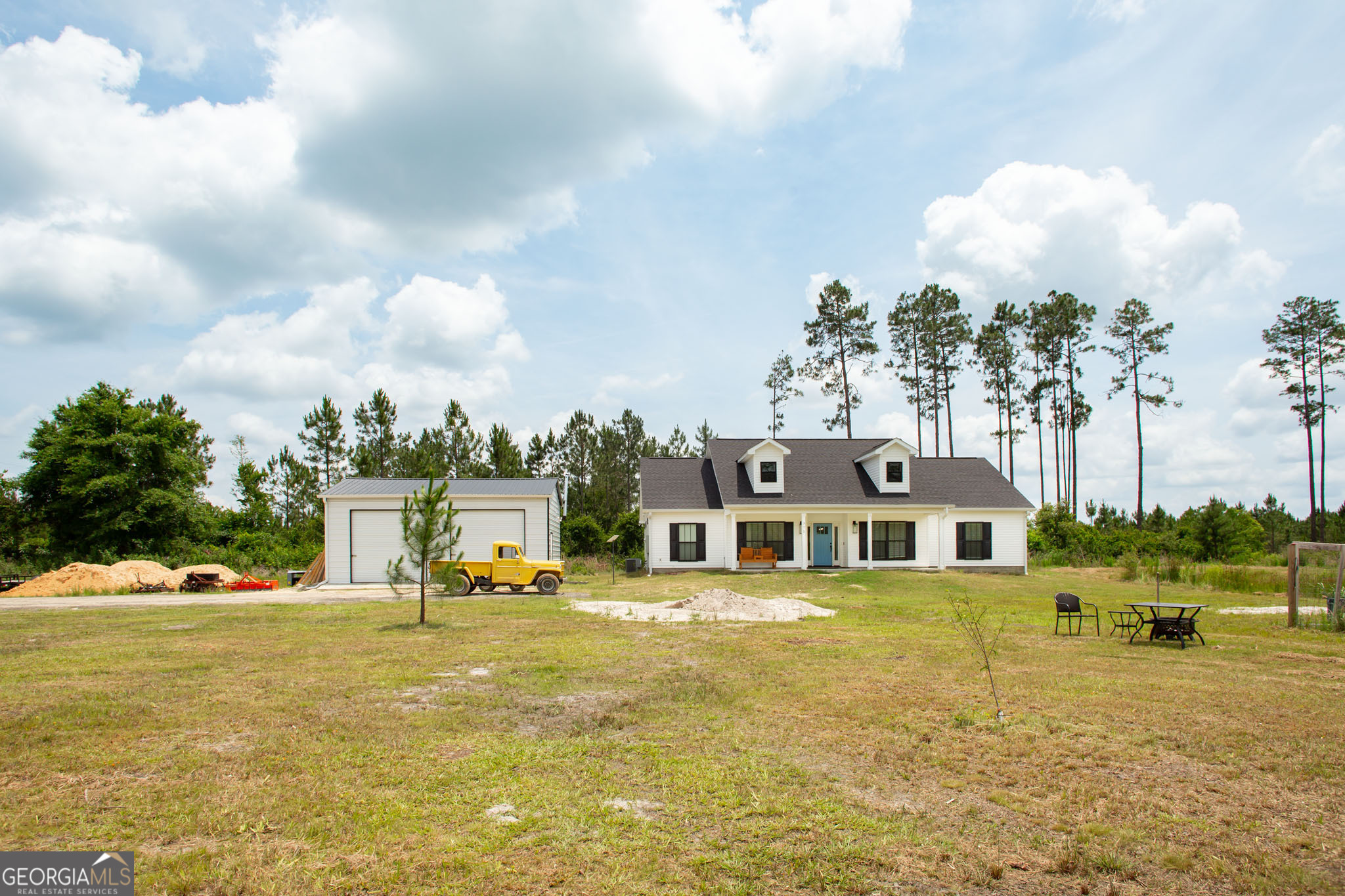 Beautiful 4 bedroom home built in 2023 in the midst of 96.3 acres. Much of the acreage features income producing planted pines. This property is located just west of Waycross, only about 10 minutes from the heart of town. You'll enjoy privacy and seclusion in your beautiful home! Inside this 2001 heated sqft house you'll find an open floorplan, formal dining, gorgeous beamed vaulted ceiling, custom cabinetry, along with many other beautiful features. A 20X30 prefab metal garage with 2 bay doors, insulation, electricity and an a/c unit to keep you cool while you work is situated conveniently next to the house. A small garden area as well as a pond are also located near the house. Your homestead awaits!