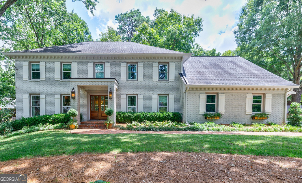 Completely redesigned and reimagined in the highly sought after Branches Swim/Tennis community, this stunning home offers a down-to-the-studs renovation with over $450,000 in custom upgrades and designer finishes. Tucked away on a quiet cul-de-sac, this painted four-sided brick home sits on a large, private lot featuring a portico addition and a fabulous fenced backyard with walkout brick patio, fire pit, and room for a pool. Inside, the bright and open floorplan is filled with natural light and custom details including archways, built-ins, designer lighting, wide plank hardwood flooring up/down, and recessed lighting throughout. The kitchen and dining area open to a vaulted great room features a T&G ceiling with beams and a floor-to-ceiling gas fireplace. New doors and double-pane windows have been installed throughout, including high-end sleek dual iron and glass doors which seamlessly lead to the backyard. The completely renovated and expanded kitchen is a showstopper, opening to a keeping room and features custom soft-close cabinetry, extensive built-ins including hidden coffee and appliance centers, quartzite waterfall island with seating, a farmhouse sink, and a full suite of premium appliances-Wolf gas cooktop, built-in refrigerator, double ovens, dual beverage drawers, a premium integrated wine cooler, and more! A separate bar area/butler's pantry makes entertaining a delight! The spacious primary suite offers a brand-new spa-inspired bath with oversized glass-enclosed shower, new dual vanity, built-in shelving for baskets, and a large walk-in closet with full organization system. Additional highlights include newly designed bathrooms throughout, an expanded bedroom with built-in beds and drawers, a laundry/mudroom with built-ins and bench seating, and a finished basement with entertainment room and additional storage/flex space. Located close to GA-400, Dunwoody Village, Perimeter, and top-rated public and private schools, this move-in ready home is the perfect blend of luxury, functionality, and location!