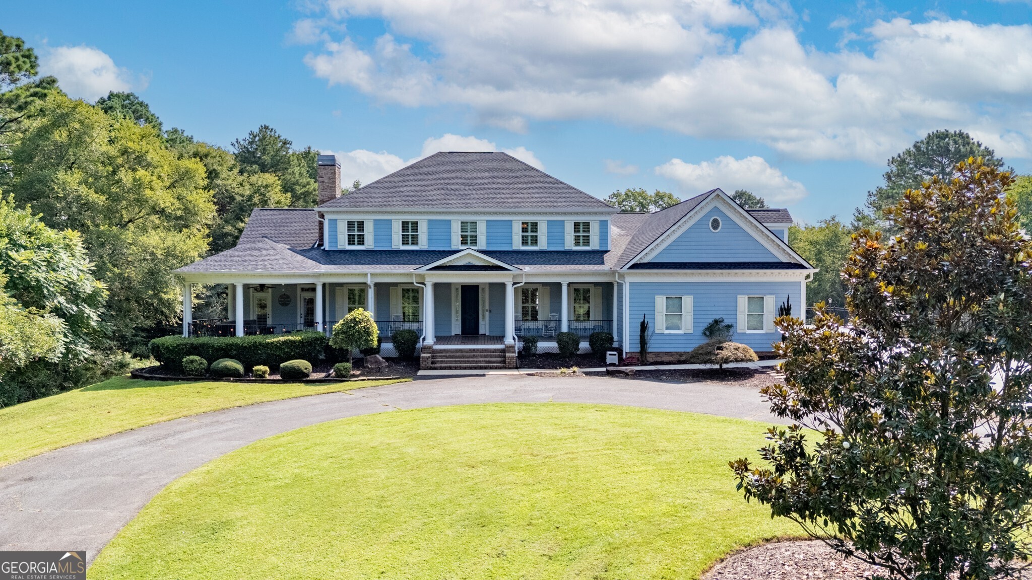 Private estate in country setting offers proximity to "town" and a quiet retreat when at home! If a blend of country and convenience is what you seek, this custom built home on 9 gorgeous acres in a rural section of Bartow may be the perfect fit. Leave the worries of the workday behind as you wind up the private driveway (please do not come up driveway without an appointment) and arrive at this 4600+ square foot traditional home positioned among a mix of woods and mature landscaping. The wide front porch welcomes all, providing space for rocking chairs and a sitting area under the gazebo style roof on the west end of the home. Step into the soaring foyer with gleaming tile floors and choose whether to enter an impressive office with custom built-ins and the first of two wood burning fireplaces, a formal dining space, or the living room, all with warm hardwood floors. The sweeping front staircase and paneled-ceiling hallway passage show off this two story home's charm and character. Large windows throughout the home allow natural light to fill the rooms. From the sunny living room, split off one direction to the large eat-in kitchen or the other to one of TWO primary suites this home has to offer. The downstairs owner suite features a large trey-ceilinged bedroom with back porch access (the pool is steps away!) and a classically outfitted bathroom with double vanity, separate tub and tiled shower - but the real hallmark of this suite is the massive walk-in closet with front porch access! Traversing back down the hallway, stop momentarily to take in the generously sized laundry room also with back porch access. Admire the built-ins and fireplace of the living room (see the balcony above?) and head into the over-sized kitchen where meal prep will be a dream with stone counters, a large breakfast bar with seating, soaring solid wood cabinets, and a stylish and practical tile backsplash. The stainless steel set of appliances completes this clean and beautiful kitchen. Amble out to the pool from either the breakfast nook or from the hallway adjacent to the kitchen. Off this handsomely tiled hallway you'll find backyard access, a convenient half-bath which pool partiers can use without tracking wet footprints through the house, garage access, and the rear stairway. Follow those stairs up to the massive bonus room, already showcasing the amount of room available for games or movie viewing. Atop the second floor find two more large bedrooms which share hall bath access with a double vanity and tub shower combo. At the end of the hallway (you won't miss the chance to peer down into living room from the balcony) sits the second of the home's primary suites. Another generously sized bedroom leads into a 4-piece bath, but a secret lies within this seemingly straightforward bathroom: enter the closet and discover ANOTHER fully finished space beyond the closet, sure to inspire the creativity of this home's next owner. This could be an office, a dressing room, art/podcast studio - your imagination is the limit! Also accessible from this space is additional unfinished attic storage. With all this house to see it's easy to forget there's a beautiful backyard to explore! Summer days were made for this back porch with pool and lush lawn! And the wrought iron fencing ensures pets have a safe space to roam without being tempted to explore the whole 9 acres. This home is a treasure which needs to be seen to be appreciated! All information deemed reliable but should be confirmed by buyer.