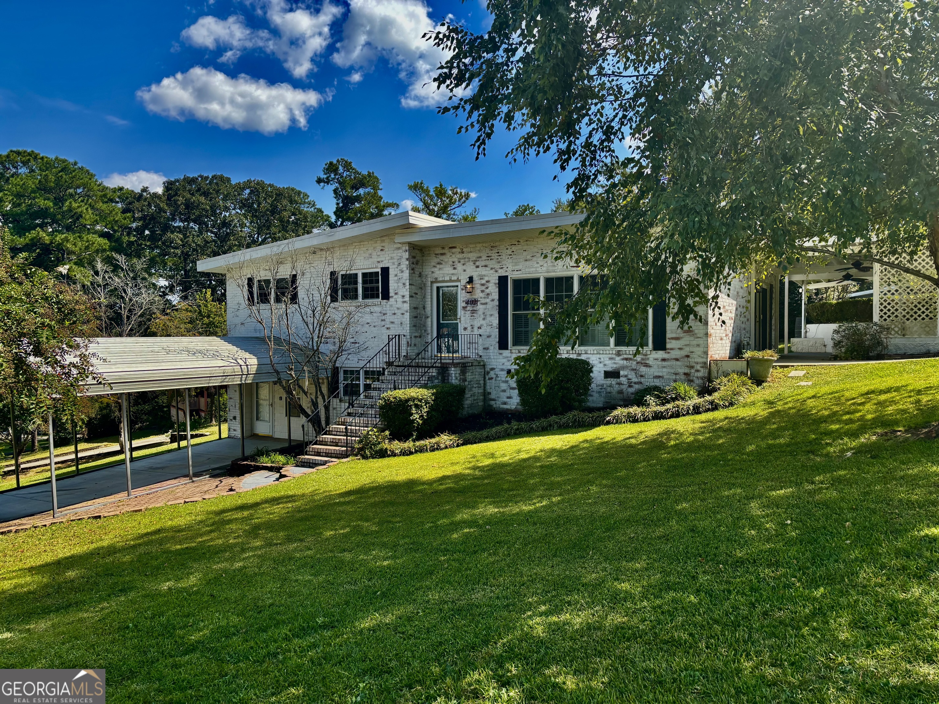 Welcome home to this trending yet timeless mid-century modern styled beauty! From the1/3 acre corner lot @ a quiet cul-de-sac, to the 4-sided brick's antique-washed aesthetic giving "Old World" charm, to the updated interior with a completely renovated kitchen-you'll find there's no shortage of features to love calling HOME. Granite countertops, all updated cabinetry featuring soft-close drawers, stainless steel appliances including fridge, & updated fixtures. Remainder of this MOVE-IN READY 3-bedroom, 2-bath home is accented by lots of natural light, with Plantation blinds & stylish woven wood shades already in place. Also features covered parking, lower-level & mid-level entry doors, updated interior paint, MASSIVE walk-in closet for primary bedroom, brand new carpet in bedrooms, &real hardwoods through the remainder of the living areas. Extra room in lower level is perfect as office/study, den, bonus, or even4th bedroom. Outside through the dining area's French doors is a large, private porch with dual fans, & just a stroll across the backyard is a fantastic, 2-story wired shop with its own scenic, porchfront overlook to the neighborhood. Bump this up a notch to create any kind of hobby studio, a stylishly crafted rustic entertainment hangout... or even your very own future "barndo" guest /teen suite or Airbnb cottage(!). Prior owners replaced all exterior doors (including storm doors) & all windows with energy efficient double-panes, & updated electrical &plumbing systems. Exterior walls insulated. HVAC replaced 2019. CALL TODAY for a personal tour of this property before it's gone!