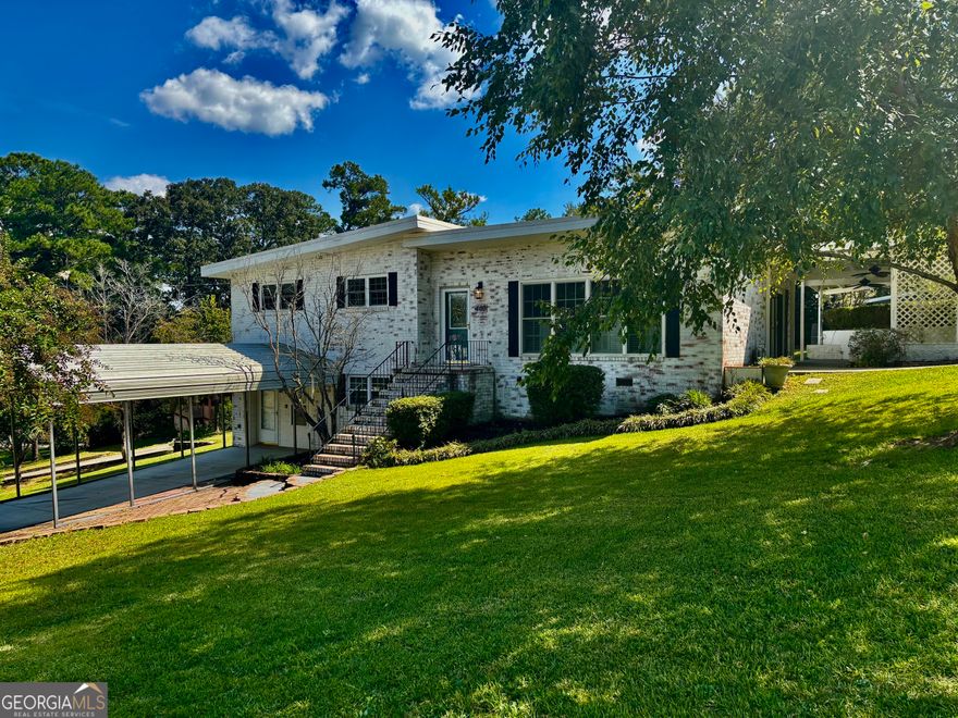 Welcome home to this trending yet timeless mid-century modern styled beauty! From the1/3 acre corner lot @ a quiet cul-de-sac, to the 4-sided brick's antique-washed aesthetic giving "Old World" charm, to the updated interior with a completely renovated kitchen-you'll find there's no shortage of features to love calling HOME. Granite countertops, all updated cabinetry featuring soft-close drawers, stainless steel appliances including fridge, & updated fixtures. Remainder of this MOVE-IN READY 3-bedroom, 2-bath home is accented by lots of natural light, with Plantation blinds & stylish woven wood shades already in place. Also features covered parking, lower-level & mid-level entry doors, updated interior paint, MASSIVE walk-in closet for primary bedroom, brand new carpet in bedrooms, &real hardwoods through the remainder of the living areas. Extra room in lower level is perfect as office/study, den, bonus, or even4th bedroom. Outside through the dining area's French doors is a large, private porch with dual fans, & just a stroll across the backyard is a fantastic, 2-story wired shop with its own scenic, porchfront overlook to the neighborhood. Bump this up a notch to create any kind of hobby studio, a stylishly crafted rustic entertainment hangout... or even your very own future "barndo" guest /teen suite or Airbnb cottage(!). Prior owners replaced all exterior doors (including storm doors) & all windows with energy efficient double-panes, & updated electrical &plumbing systems. Exterior walls insulated. HVAC replaced 2019. CALL TODAY for a personal tour of this property before it's gone!