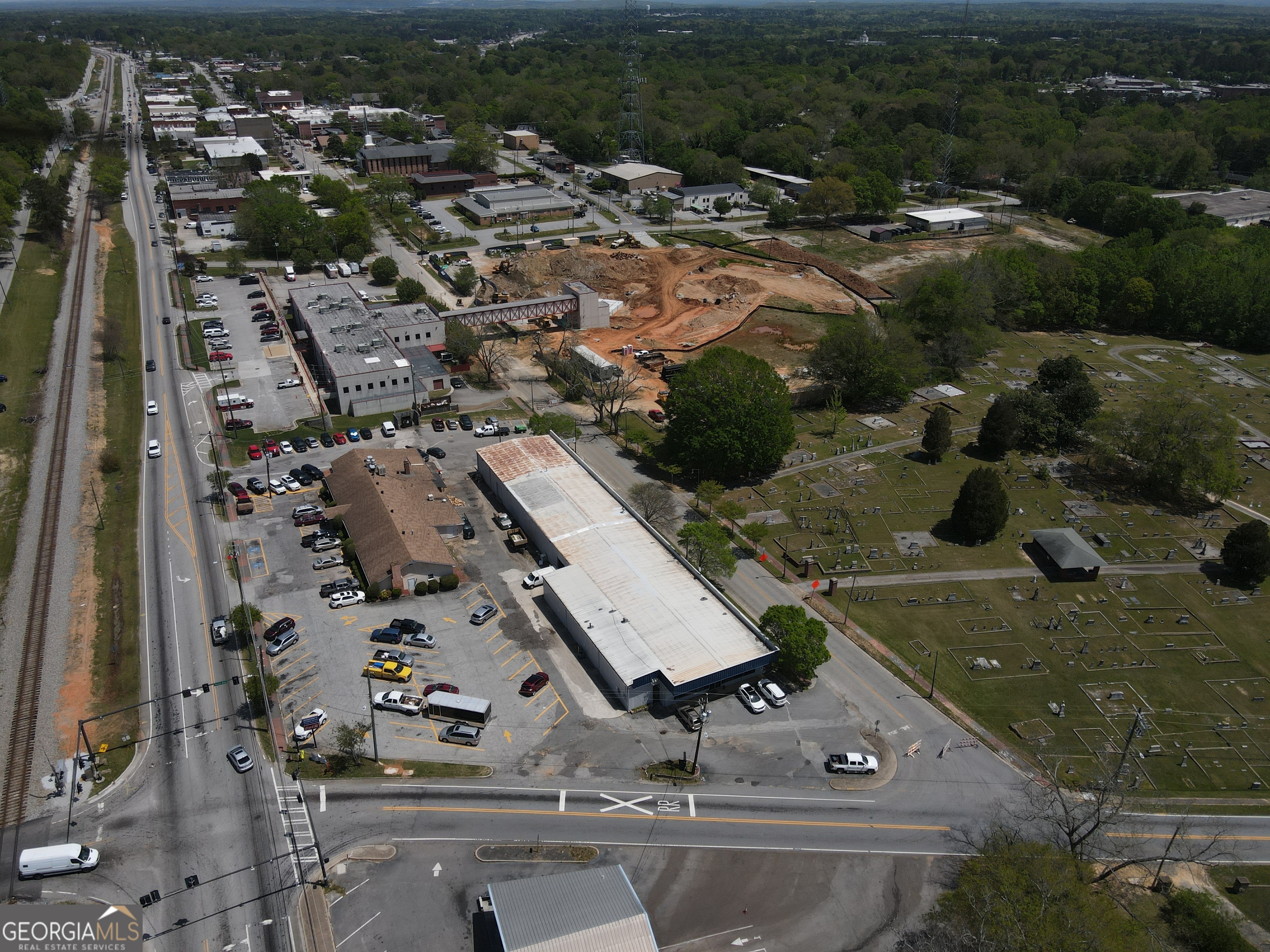 Ackerman & Co. and Pioneer Land Group are pleased to offer for sale 8550 Rose Avenue-a 12,500 SF flex space building located in the heart of historic downtown Douglasville, Douglas County. This rare opportunity sits at the high-visibility corner of Rose Avenue and Church Street, offering approximately 115 feet of frontage on Rose Avenue and 325 feet on Church Street. Positioned directly adjacent to the new Douglasville Town Green, currently under construction, the property will soon benefit from its proximity to future retail, multifamily residences, and the Greystone Power Amphitheater-bringing foot traffic and vibrancy to the area. 8550 Rose Avenue is located within the recently approved Douglasville Tax Allocation District (TAD), enhancing its potential for redevelopment or investment incentives. Originally built in 1970, the metal flex building includes approximately 1,260 SF of office space, 2,100 SF of showroom, and 9,140 SF of warehouse. The structure features 16-foot clear heights on the sides and 18-foot clearance at the center, with a 10'x10' roll-up garage door providing easy access. The building also contains two restrooms.