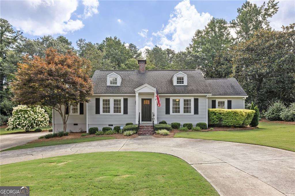 If you've been dreaming of life in East Cobb's most coveted school trifecta-Soap Creek, Dickerson, and Walton, then grab your sweet tea and get ready, because this one checks every box and then some. Sitting pretty on a completely flat .65-acre corner lot, this 3-bedroom, 2-bath Cape Cod-style bungalow blends cozy charm with big-time potential. From the circular driveway (with parking for all your people) to the lush, grassy yard that's ready for playdates, pups, or even a future pool, this home offers room to breathe and space to grow. Inside, you'll find gleaming hardwood floors, a crisp, updated kitchen, and two beautifully renovated bathrooms. All three bedrooms, including the primary all on the main level, making this layout ideal for a young family, empty nesters, or anyone looking for easy, one-level living. The cozy family room is perfect for curling up with a good book by the fire or watching the big game, while a sitting room or perfect work from home space with French doors that spill out to the oversized deck is just begging for your next backyard BBQ or morning coffee moment. Need a little more room in the future? You've got permanent stairs to the attic and space to expand if you want to add on or better yet... you're sitting on a premiere building lot. You're surrounded by multi-million-dollar homes, so whether you're buying for yourself or scooping up a smart investment, this home is holding strong in good company. Updated, loved, and located in one of the best pockets of East Cobb, The Dickerson House is more than just a smart move, it's the kind of place that feels like home the minute you pull in the drive. Picket fence perfect, no pretense, just pure potential and Southern comfort. Come see it before it's gone.