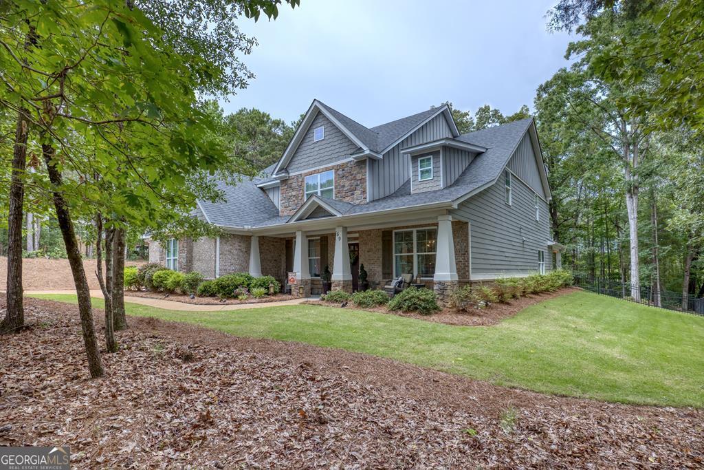 Meticulously maintained 5 bedroom, 4 bath home situated on a 1 acre, beautifully landscaped lot that is surrounded by mature trees. Primary suite is on the main level and features a vaulted ceiling, large sitting area, beautiful natural lighting, walk-in closet with custom built-ins, a relaxing ensuite w/soaking tub, tiled shower, double vanities, and great storage. Also on the main level is an office with French doors as well as a full bathroom. Large open concept kitchen with granite countertops, updated lighting, wood flooring, island w/stained wood top, a breakfast area overlooking the back yard, a butler's pantry w/stained wood counters and a wine cooler. Great room has 12' ceilings, a gas fireplace and views of the back yard. Separate dining room features wainscoting and coffered ceiling. Upstairs there are 4 bedrooms, all with vaulted ceilings and walk-in closets, two full baths and a large media room. The outdoor living space in this home has a great covered patio and everything you need for entertaining and family gatherings! Attic has spray foam insulation for energy efficiency! Walk to the end of Winding Lake Drive to find a private neighborhood spring-fed fishing pond and free boat storage available. Just minutes to Lake Harding, Callaway Gardens and local restaurants!