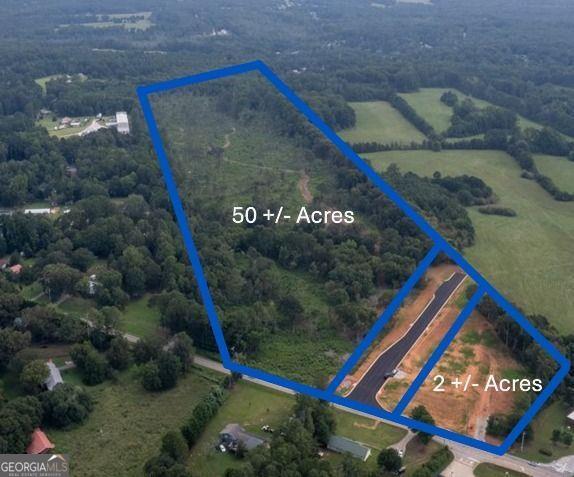 50 +/- Acres with Road Frontage of Unimproved Land. Only 11 miles from I-20 and 4 miles from Downtown Carrollton. Zoned Light Industrial in the City of Carrollton. Easy access to 61 with traffic light. All utilities are on the property with 12" water main and sewer. Additional 2 +/- Acres with Road Frontage available under separate listing.
