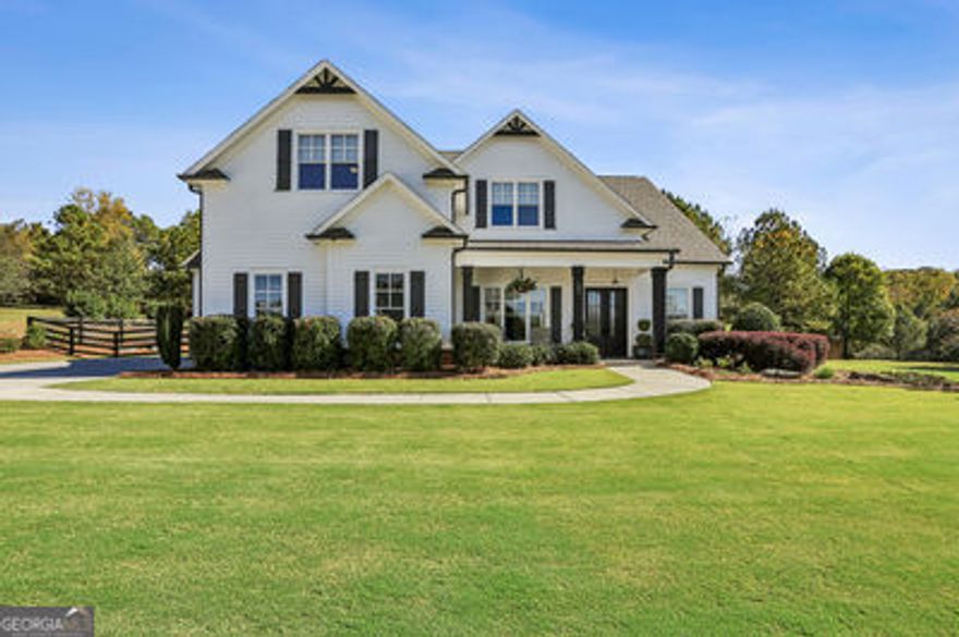 Set on two manicured acres in the prestigious Birmingham Estates community, this striking residence captures refined Southern living with modern flair. Featuring four bedrooms and three-and-a-half baths, the home blends effortless everyday comfort with luxury outdoor living. From the welcoming front porch to the sparkling sport pool and hot tub surrounded by marble decking, every space is designed for connection, relaxation, and entertaining in style. The open-concept floor plan showcases gleaming hardwood floors, abundant natural light, and thoughtful architectural details throughout. The primary suite on the main level provides a peaceful retreat with a spa-inspired bath and generous walk-in closet. The heart of the home centers around the warm fireside great room and gourmet kitchen- ideal for entertaining or everyday living-with an oversized island, custom cabinetry, and a casual dining area overlooking the backyard oasis. Upstairs, you'll find spacious secondary bedrooms and an expansive recreation room, ideal for movie nights, gaming, or guest accommodations. STORAGE IS ABUNDANT throughout, including a three-car garage, an accessible 12' x 14' temperature-controlled storage room above the garage, and well-organized closets. The covered patio with fireplace and TV makes entertaining effortless year-round, while the manicured lawn offers plenty of space for play and outdoor gatherings. Situated in one of Cherokee County's most desirable neighborhoods-known for its large estate lots, scenic setting, and charming mail pavilion-this home combines privacy, style, and convenience, just minutes from Milton, Alpharetta, and Crabapple.