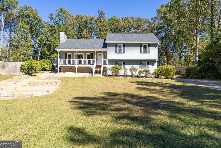 Tucked in the quiet Magnolia Walk community, this Woodstock split-level offers plenty of space inside and out! Set on a spacious, fenced lot with a huge front yard, this home welcomes you with a covered front porch leading into a bright entryway and vaulted fireside family room filled with natural light. The layout flows to a separate dining room and an eat-in kitchen with stained cabinetry and plenty of room for gathering. Upstairs, the primary suite features a walk-in closet and a tub/shower combo, while two secondary bedrooms share a nicely sized hall bath. A convenient laundry room is located in the upstairs hall. The two-car garage includes a storage closet and additional space for tools or equipment. Enjoy outdoor living on the oversized rear deck overlooking the private backyard. Recent updates include a new roof (2020), newer HVAC, new front windows and door, fresh interior paint, tree removal to open up the lot, new rear deck, front stairs, and fencing. Located in the established Magnolia Walk neighborhood with no HOA, this home offers easy access to Lake Allatoona, nearby trails and parks, Hobgood Park, Rope Mill Park, the Outlet Shoppes, and Downtown Woodstock. A wonderful opportunity to call this spacious home your own in one of Woodstock's most convenient locations!