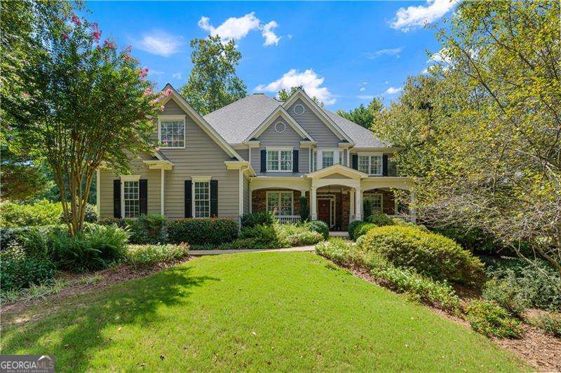 Welcome to this stunning Home in Sought-After Bradshaw Farm. As you approach this beautifully maintained home, the sidewalk leading to the front door feels like a stroll through a private botanical garden leading to the covered front deck. Inside you are welcomed with a bright two-story entry way, this spacious residence offers 5 bedrooms, 4.5 bath, and an open and inviting floor plan, with timeless finishes throughout. The main level features a living room with a fireplace, floor to ceiling windows, a formal dining room, and a chef's kitchen with double ovens, a breakfast room, a walk-in pantry, plenty of cabinet space, a guest room with ensuite bath and a home office. Upstairs, you'll find the generously sized primary suite and spa like bath, 3 additional bedrooms, 2 baths and a large bonus space, perfect for a playroom, or a home office. The partially finished terrace level offers endless possibilities, great space for a media room, game room, or gym. Step outside to a private backyard retreat situated on hole 4 at Bradshaw Farms prestigious golf course. The screened in back deck offers peace and tranquility and leads you out to a gorgeous stone patio and outdoor kitchen ideal for entertaining or relaxing. Living in Bradshaw Farms means enjoying resort-style amenities, including pools, tennis courts, playgrounds, and a championship golf course-all just minutes from top-rated schools, shopping, dining, and downtown Woodstock.