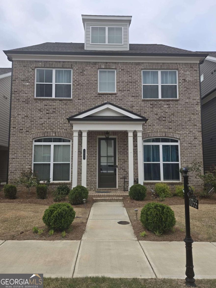 Don't miss the opportunity to own a home in one of the most desired and newly established gated communities, Central Park at Deerfield. This home boasts 3 floors of comfortable living with stunning finishings and endless upgrades. You are welcomed by a charming front porch, eye-catching Craftsman style brick exterior, meticulous landscaping, and a two-car garage in the rear. Come inside and enjoy gorgeous hardwood floors throughout, incredible 10' ceilings on the main floor, blinds, and a spacious open-concept layout. The stunning Chef's kitchen has everything you can imagine, including an oversized island with stone countertops, stainless steel appliances, bright white cabinets stacked to the ceiling and a large pantry. The kitchen flows effortlessly into the cozy great room equipped with a gas fireplace and box beam mantle. Double doors make way to the private back patio-- perfect for enjoying a book, entertaining, or simply relaxing! The main level is made complete with a huge dining room, mudroom and easily accessible Guest ensuite including a full bath. Upstairs you will find an elegant Owner's Suite with dual vanities, a luxurious soaking tub w/ separate shower and two expansive walk-in closets. Additionally, there are three gracious secondary bedrooms upstairs with additional baths and a convenient laundry room. The third floor contains another large bedroom, additional full bath and flex/loft space which makes the space perfect for a multigenerational family or an individual that works remotely! Additional unfinished attic space to use for storage or convert to additional living space. Conveniently located just minutes from Alpharetta's thriving Downtown, The Avalon, & Halcyon shopping/dining. Amazing community amenities including a 12-acre park & trails, clubhouse, pool, tennis, & playground. Highly rated Forsyth County schools & low Forsyth taxes!! Don't let this home be "the one that got away", schedule your showing today.