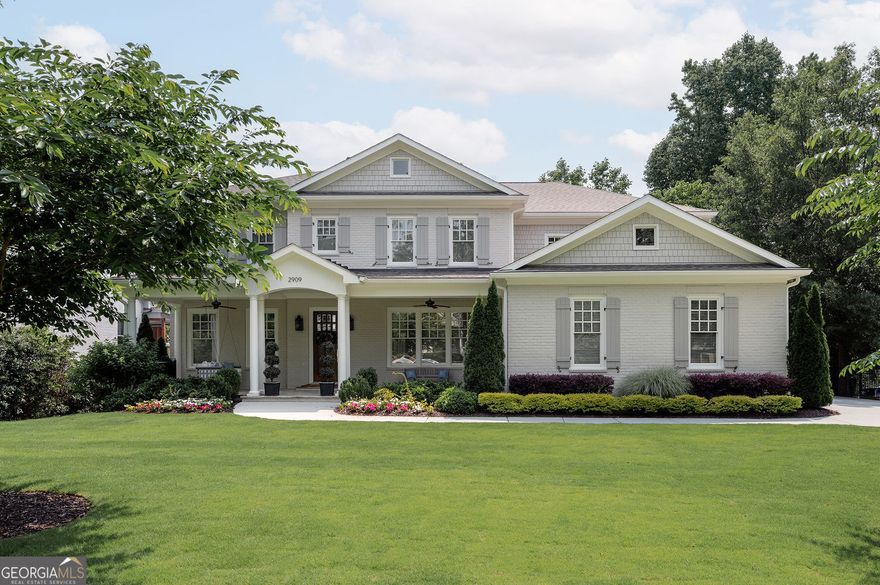 Welcome to 2909 Redding Rd-an award-winning, professionally curated home tucked away on one of Ashford Park's most desirable streets. From the moment you arrive, the refreshed landscaping and charming bluestone front porch invite you in, creating the perfect setting for quiet summer evenings on the swing. Inside, natural light floods the open spaces, where custom details like wainscoting and oversized barn doors elevate the living and dining areas. Just past the staircase, a private ensuite bedroom-currently used as a home office-offers a quiet escape, enhanced by rich tones and upgraded lighting. The heart of the home is the open-concept family room and kitchen, thoughtfully designed for both everyday living and entertaining. Built-ins provide style and function, while the bright, airy kitchen features a Thermador range, vent hood, and refrigerator/freezer. Floor-to-ceiling windows and sliding glass doors draw you onto the screened porch, complete with a fireplace-an ideal indoor-outdoor living space year-round. Upstairs, the primary suite is a true retreat with a spa-like bathroom and an expansive custom walk-in closet. Three additional ensuite bedrooms-two with award-winning designs-offer serene, beautifully crafted spaces for family or guests. A spacious laundry room adds extra convenience. The newly finished basement was designed with entertaining in mind, featuring a large living area with a bar, custom storage, a full bathroom, and an additional bedroom-perfect for guests, movie nights, or game days. The private backyard is a blank slate with plenty of space to bring your outdoor dreams to life-whether it's a lush garden, play area, or an infinity-edge pool. Lovingly maintained by its original owner, this exceptional home is move-in ready and waiting for its next chapter.