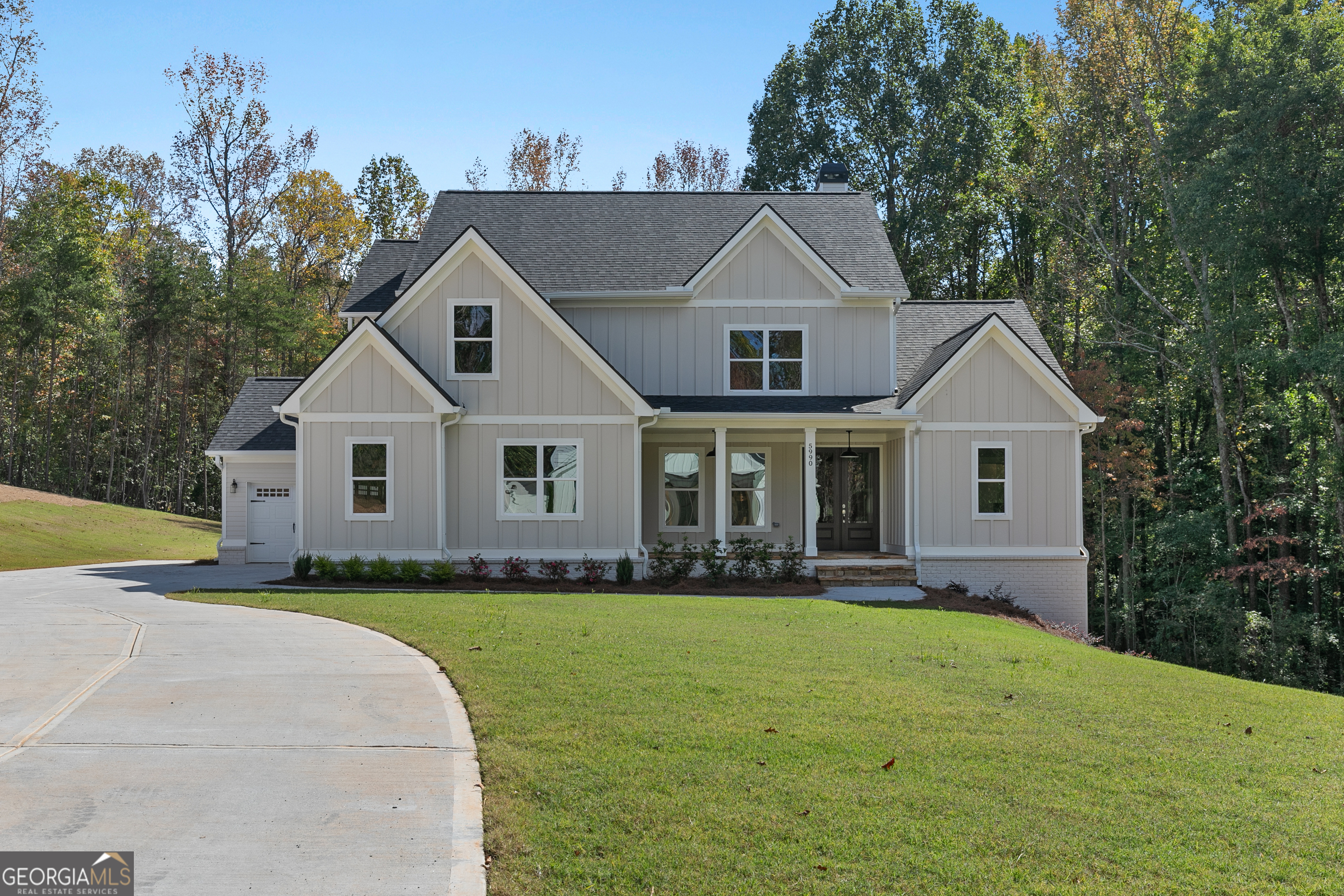 Set on 6.42 private acres near Lake Lanier, this new construction opportunity at 3 Henry Pirkle Dr. in Dawsonville offers the rare chance to design your home from the ground up. Buyers can fully customize the architecture, layout, materials, and finishes to match their vision-whether modern farmhouse or classic Southern design. The attached photos show a completed build of this plan, featuring bright open living spaces, a large chef's kitchen, elegant bath design, and an inviting covered deck with a fireplace overlooking wooded views. Conveniently located near the lake, parks, and Dawsonville shopping, this homesite combines privacy with accessibility and the freedom to create a truly personalized retreat.