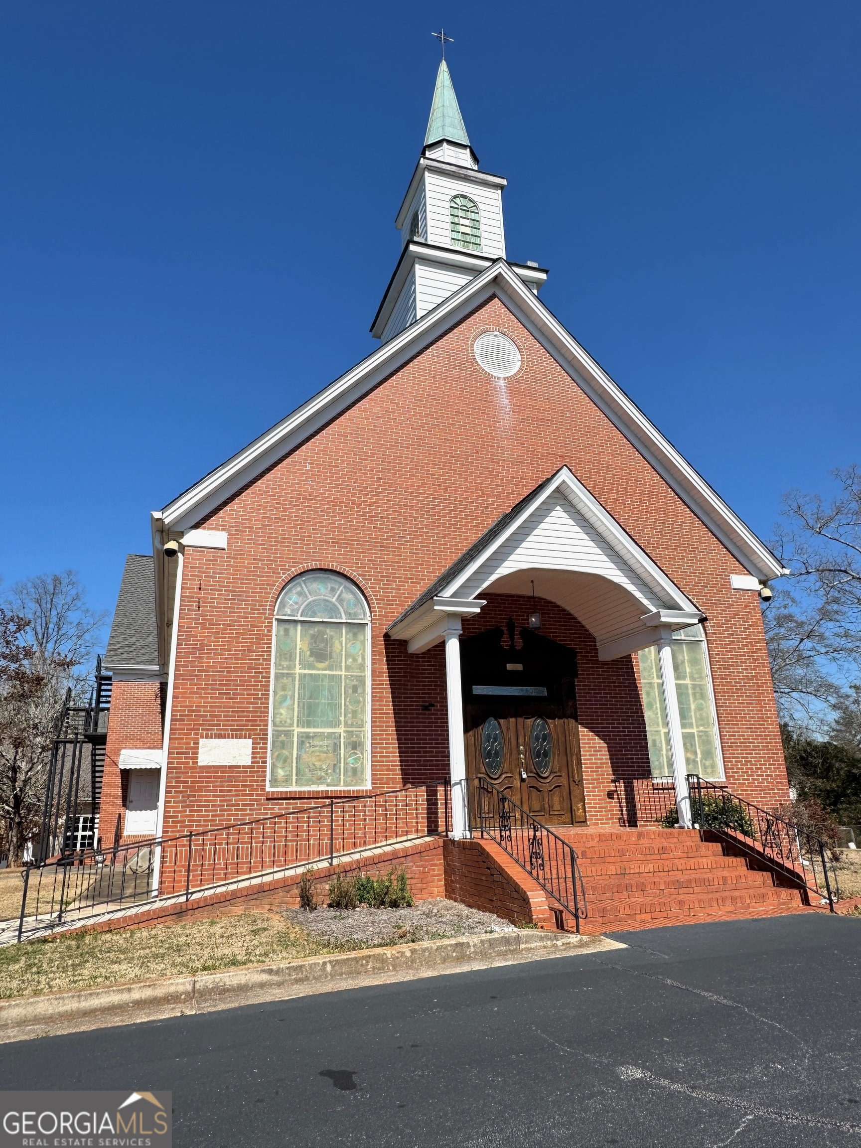 This exceptional church property in McDonough offers a versatile campus with four buildings totaling 16,144 square feet on 4.68 acres. The main church building, built in 1958, features a 2,030-square-foot sanctuary accommodating approximately 200 people, along with multiple classrooms, offices, and storage across three oors. A modern fellowship hall, constructed in 2002, boasts a spacious 3,400-square-foot open area with soaring ceilings, a large commercial kitchen, and additional storage. The front office/preschool building, built in 1965, includes six classrooms/offices, a kitchen, and 1.5 bathrooms -- perfect for Sunday school or community programs. Completing the property is a charming back parsonage house, built in 1963, offering 3 bedrooms, 2.5 bathrooms, a full kitchen, living and dining areas, an un nished basement, and an attached garage. With approximately 100 parking spaces, this property is ideal for a growing congregation, community center, or educational facility, offering both versatility and practicality.