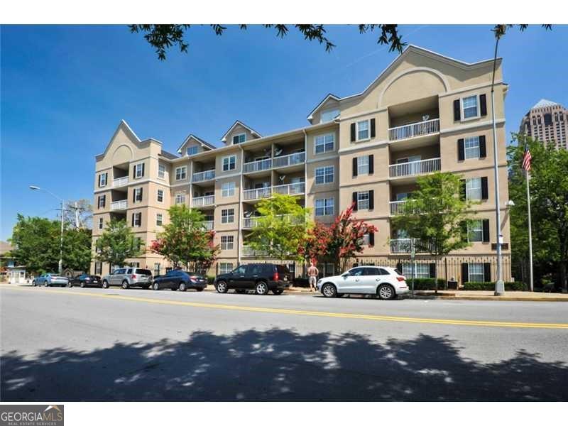 Location, Location, Location! Don't miss your chance to own a piece of Midtown's best-kept secret! This top-floor loft unit at Peachtree Walk Condos offers the perfect blend of Midtown lifestyle with incredibly low monthly assessments! Ideally situated in the heart of Midtown, this condo offers walkable living with everything you need just steps away: shopping, restaurants, MARTA, Georgia Tech, Georgia State, SCAD, the iconic Fox Theatre, and much more. Peachtree Walk Condos is a fantastic community made up of two mid-rise buildings, offering top-tier amenities: A pool to relax and unwind, Conference room for meetings or work sessions, a full fitness center to stay active, Lobby area for visitors, Electric car charging stations, Two covered parking spaces, Guest parking decks, A full-time onsite Property Manager! The top-floor unit boasts panoramic views from the living room, and the main floor features a spacious bedroom and full bath. A striking spiral staircase leads you to the incredible loft-style owner's suite.