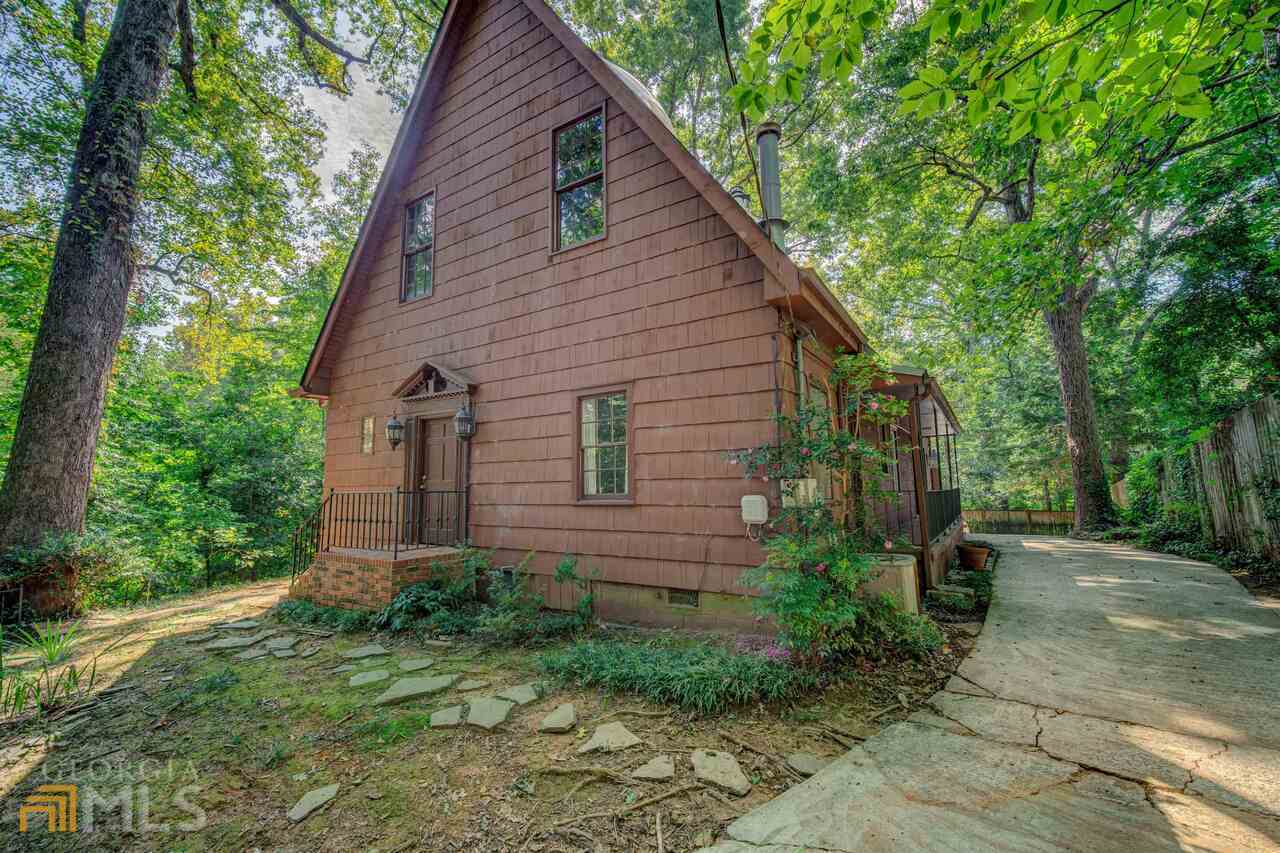Incredible opportunity steps from Emory University on Clifton Road. This 5 bed/4 bath European, farmhouse style home features stunning beam work, French doors, wood floors throughout, a huge kitchen with wood cabinetry ready to be refinished, master bedroom and secondary bedroom/bathroom on main, a great room with vaulted beamed ceilings and wood burning stove. Several loft areas in upstairs and 3 additional bedrooms and 2 full baths. Located on a hilltop lot steps to shops, restaurants and more. Property needs renovation and is being sold as-is. Electricity in process of being turned on so best to view in day time hours.