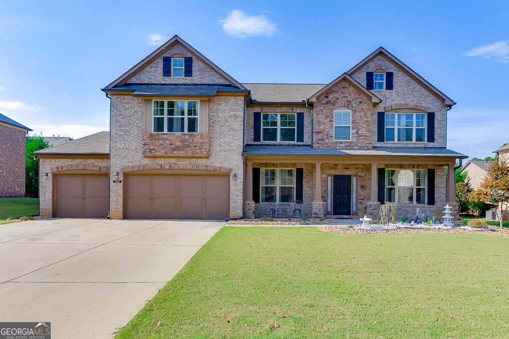 This beautifully maintained Sugar Hill home offers comfort, quality upgrades, and timeless appeal. Southeast-facing, it's filled with natural light that enhances its open and airy design. Built in 2017, the home features three sides of brick, a three-car garage, and a versatile modern style that can easily be personalized with simple updates to fixtures. The main level includes an office, formal dining room, guest bedroom with full bath, a soaring two-story great room, and a gourmet kitchen with an oversized island and abundant counter space-perfect for both daily living and entertaining. An enclosed sunroom overlooks the thoughtfully landscaped backyard and provides a cozy retreat, complete with a custom vented outdoor grill. Upstairs, you'll find three spacious secondary bedrooms-two sharing a hall bath and one with its own private bath-plus an impressive oversized primary suite. The spa-like bathroom offers dual vanities, a soaking tub, a tiled shower, and a large walk-in closet. The backyard is fully fenced and designed for relaxation, featuring a tranquil koi pond and an additional deck for outdoor cooking or entertaining. Located in the gated Warrenton neighborhood, residents enjoy sidewalks, a playground, and a true sense of community. With close proximity to shopping, dining, hospitals, and easy interstate access, Sugar Hill offers the perfect balance of convenience and charm. Welcome home!