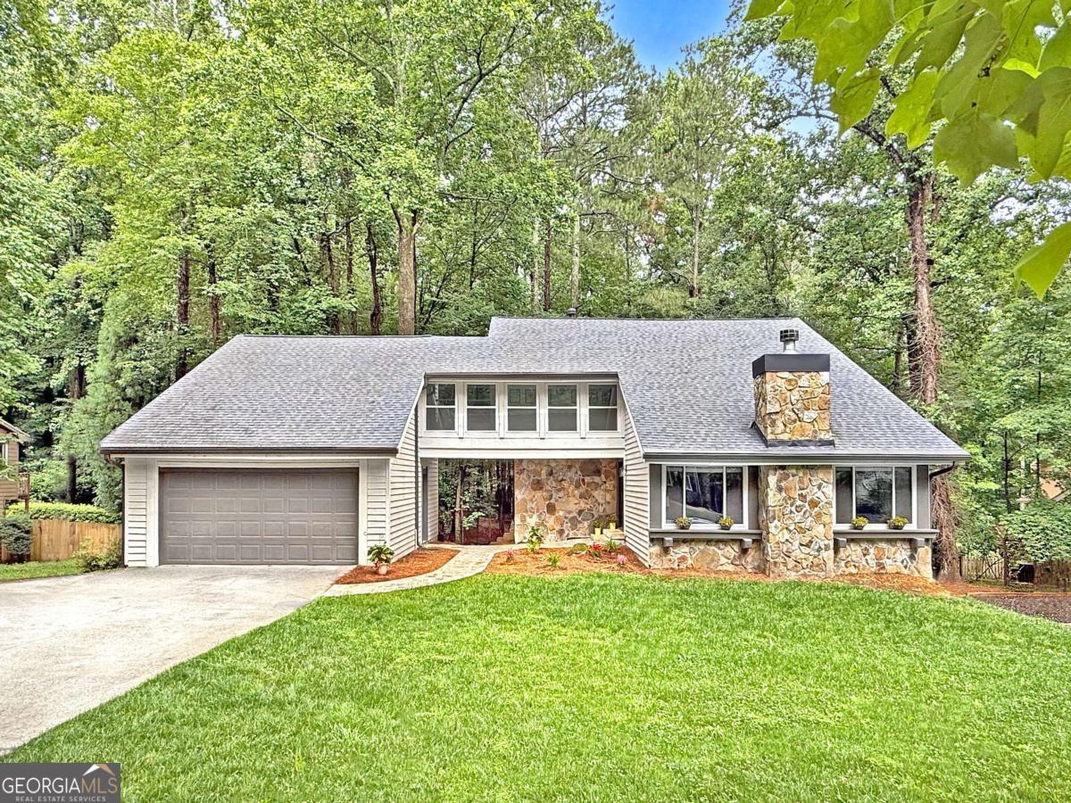 WELCOME HOME to this unique, completely updated 4 bedroom, 2.5 bath home perched on a 3/4 acre lot in highly sought-after Country Club of Roswell - Willow Springs! This fabulous contemporary home features thoughtfully appointed on-trend finishes throughout, open-concept floor plan, loads of natural daylight, and so much more! The main living level includes a light, bright two-story fireside living room, dining area, half bath, and light-filled family room, open to the beautifully designed eat-in kitchen complete with quartz countertops, soft-close cabinetry, stainless appliances, and eye-catching stainless apron sink, all overlooking the back deck and lush tree canopy of the wooded backyard! Upstairs, you'll find 3 sizable guest bedrooms, guest bathroom, and the vaulted primary bedroom including dual linear closets and ensuite bath with double vanity and walk-in shower. The full daylight walk-out terrace level is unfinished and ready to customize to your liking! Outside, you'll find plenty of space for entertaining or just relaxing on the large deck off of the main level that overlooks the private wooded fenced-in backyard. Newer everything including roof, windows, HVAC, water heater, doors, garage door- truly move-in ready! The Country Club of Roswell (membership not included) offers tons of fabulous amenities such as a pool, golf course, tennis courts, workout facilities, bar, wine club/dinners, full dining service, and much more! Very active HOA with loads of family activities, concerts/movies at the park and more throughout the year! Don't miss the opportunity to make this amazing home your own!