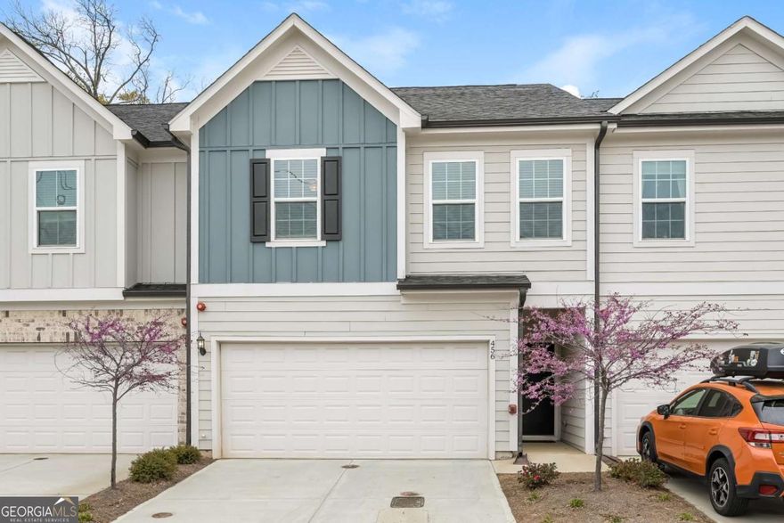 This meticulously maintained, like-new townhome offers carefree living within walking distance to the Marietta Square with 2100 sqft. The open main level features engineered wood floors, a chef's kitchen with white quartz counters, a five-burner gas cooktop, an expansive island, and stainless steel smart appliances, seamlessly flowing into the open dining area and sunlit living area with its wall of windows-perfect for entertaining. Step outside to the back patio on one of the more private lots in the neighborhood. Upstairs, walk right into the loft which provides great space for a second living area, perfect for movie nights or a home office. Two sun-filled bedrooms share a hall bath, while a spacious laundry room adds convenience upstairs. The private primary suite is its own sanctuary with double-door entry and ample lighting. The spa-like primary bath is covered in gorgeous tile with a frameless glass fully tiled shower, separate soaking tub, dual vanity, linen closet, and a large walk-in closet. Additional conveniences include a two-car garage with electric car charging and numerous smart home features. An HOA that handles exterior maintenance, lawn care, and termite control makes for carefree living. Community perks include a dog park, guest parking, fire pit, and walking trails. Don't miss your chance to enjoy a walkable lifestyle in this highly desired location, just a short walk over the pedestrian path to Marietta Square- with its weekly farmers market, food hall, frequent events, with local dining and shopping options!