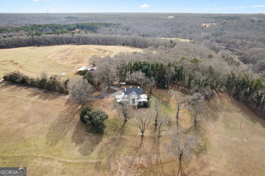DEVELOPERS DREAM! Welcome to Rocky River Plantation, formerly known as "Valley View," a Southern masterpiece along the Rocky River. Step back in time and immerse yourself in the elegance of the early 20th century with this stunning Greek Revival estate, located at 2000 East River Street, Anderson, SC. Built in 1913 by Mr. Seybt, this historic home is a true architectural gem and a rare opportunity to own a piece of Southern history. Nestled on 62.34 acres of picturesque land, Rocky River Plantation seamlessly combines timeless grandeur with modern potential. The 4,000-square-foot home is a commanding structure featuring ten spacious rooms, two room-sized halls, a basement, and a permanent staircase leading to two attic rooms. The first floor boasts soaring 11-foot ceilings, while the second floor stands at an impressive 10 feet. The craftsmanship is impeccable, with two-inch slash pine floors intricately laid in patterns and architectural details such as front-facing columns and additional columns within the grand entrance hall. A large wrap-around porch further enhances the home's charm, offering the perfect space to enjoy serene views and Southern hospitality. Designed by architects Joe Casey and Charles W. Fant, Sr., this home has been cherished by notable owners, including former U.S. Congressman John C. Taylor and his family. Beyond the house itself, the expansive grounds offer over 2,000 feet of frontage along the scenic Rocky River, providing breathtaking natural beauty and abundant recreational opportunities. Additionally, the property boasts 2,600 feet of road frontage along US Highway 178, offering unparalleled access and visibility. Located in the heart of Anderson, South Carolina, Rocky River Plantation is centrally positioned at the intersection of US Highway 178 and US Highway 29. The property is un-zoned and unrestricted, with all major utilities in place, including sewer, high-KVH power, a 10-inch natural gas line, fiber, and a 12-inch water line. These features make the estate a prime redevelopment site for multi-family residential, commercial, or industrial projects. Rocky River Plantation stands as a testament to enduring beauty and refined Southern living. Whether you dream of restoring this historic treasure to its original glory or envisioning a modern redevelopment that harnesses its potential, this estate offers a truly unique canvas for your vision.